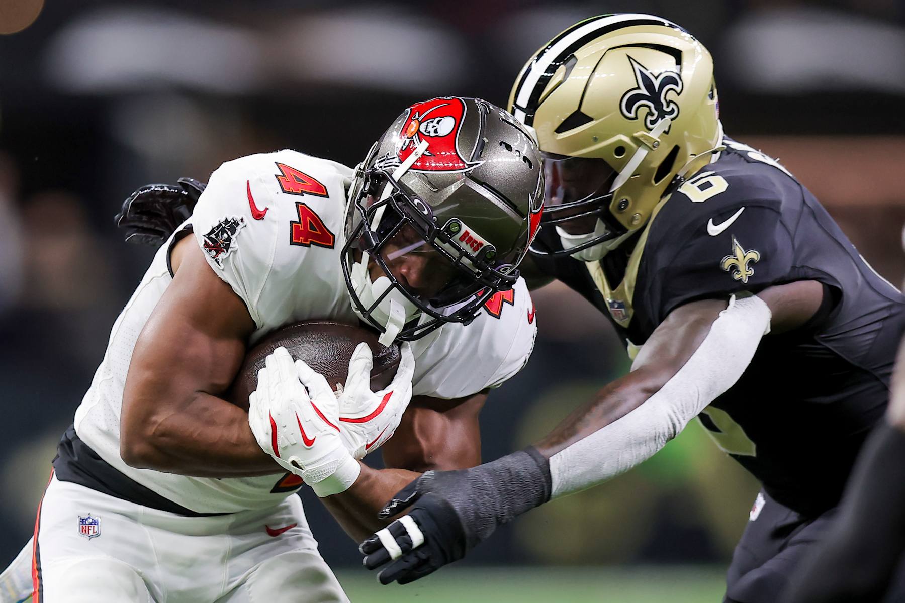 NEW ORLEANS, LOUISIANA - OCTOBER 13: Sean Tucker #44 of the Tampa Bay Buccaneers carries the ball against Willie Gay #6 of the New Orleans Saints during the first quarter at Caesars Superdome on October 13, 2024 in New Orleans, Louisiana. (Photo by Jonathan Bachman/Getty Images)