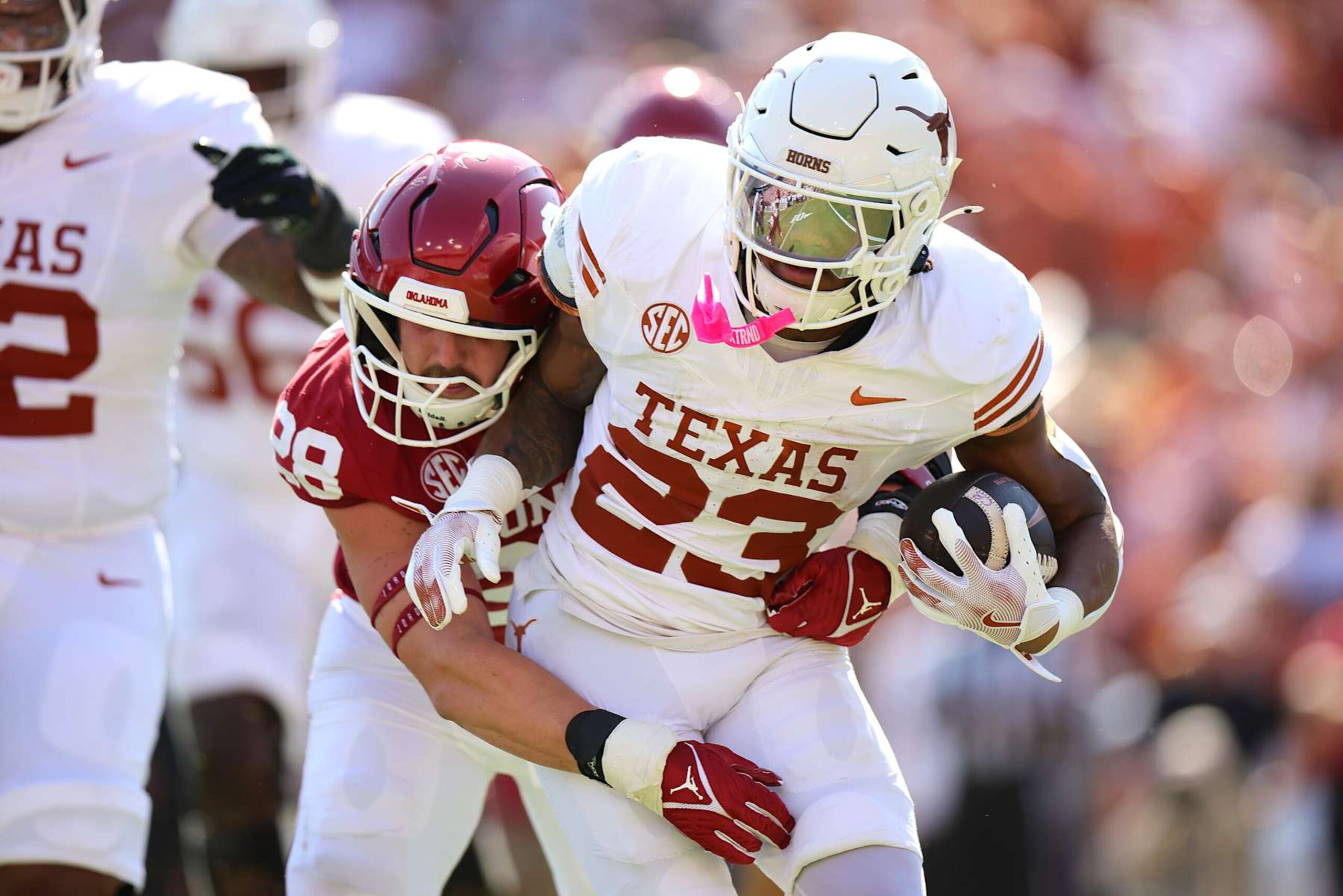 DALLAS, TEXAS - OCTOBER 12: Jaydon Blue #23 of the Texas Longhorns runs the ball against Danny Stutsman #28 of the Oklahoma Sooners during the first quarter at Cotton Bowl Stadium on October 12, 2024 in Dallas, Texas. (Photo by Alex Slitz/Getty Images)