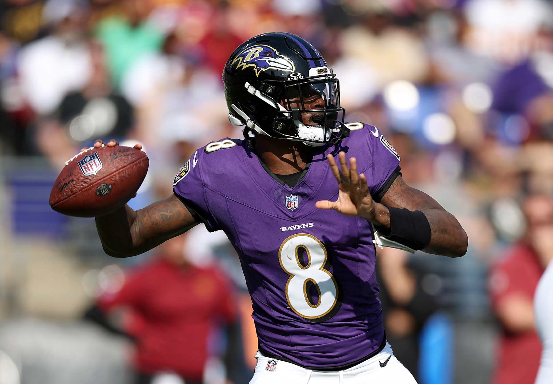 BALTIMORE, MARYLAND - OCTOBER 13: Lamar Jackson #8 of the Baltimore Ravens throws a pass against the Washington Commanders during the second quarter at M&T Bank Stadium on October 13, 2024 in Baltimore, Maryland. (Photo by Rob Carr/Getty Images)