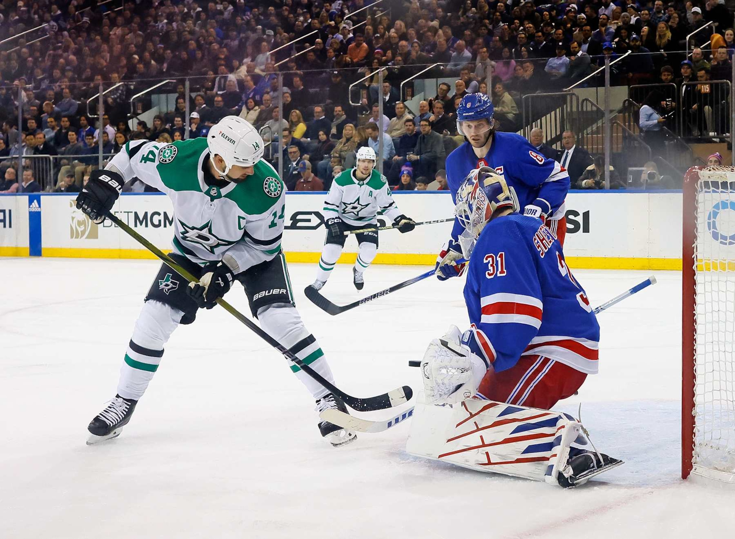 New York Rangers goaltender Igor Shesterkin (right) makes a save against Dallas Stars captain Jamie Benn. 