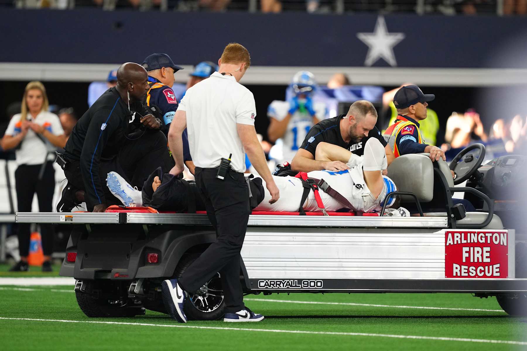 ARLINGTON, TEXAS - OCTOBER 13: Aidan Hutchinson #97 of the Detroit Lions is taken off the field on a medical cart after injuring his leg on a play in the third quarter of a game against the Dallas Cowboys at AT&T Stadium on October 13, 2024 in Arlington, Texas. (Photo by Sam Hodde/Getty Images)