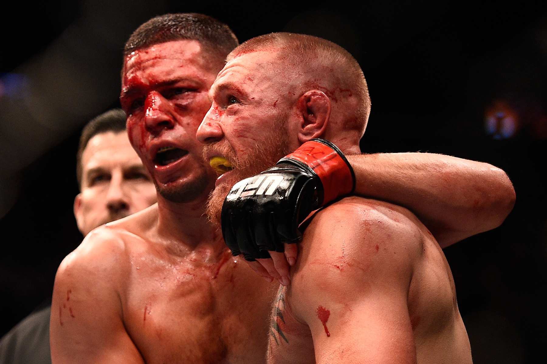 LAS VEGAS, NV - AUGUST 20: (L-R) Nate Diaz and Conor McGregor of Ireland embrace after finishing five rounds in their welterweight bout during the UFC 202 event at T-Mobile Arena on August 20, 2016 in Las Vegas, Nevada. (Photo by Jeff Bottari/Zuffa LLC/Zuffa LLC via Getty Images)