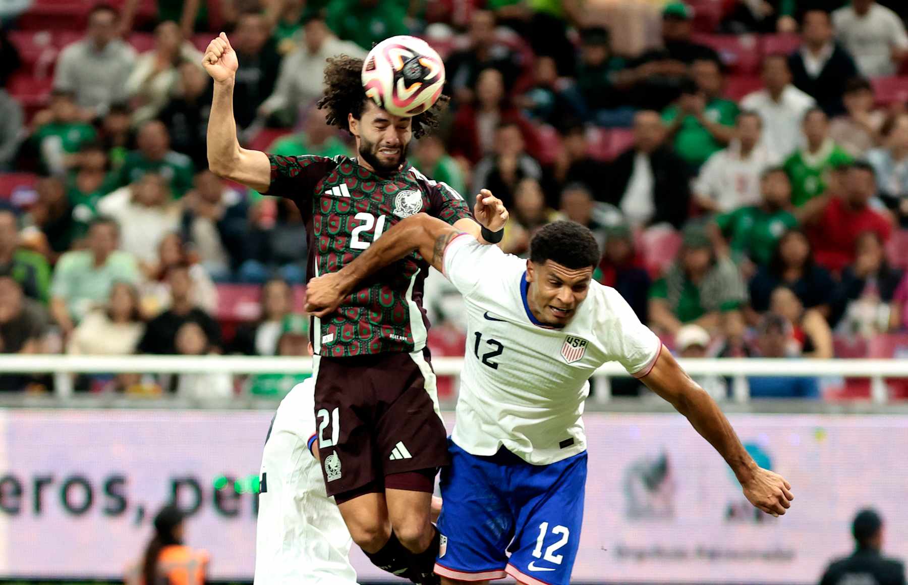 Mexico's forward #21 Cesar Huerta and USA's defender #12 Miles Robinson fight for the ball during the international friendly football match between Mexico and USA at the Akron Stadium in Zapopan, Jalisco state, Mexico, on October 15, 2024. (Photo by Ulises Ruiz / AFP) (Photo by ULISES RUIZ/AFP via Getty Images)