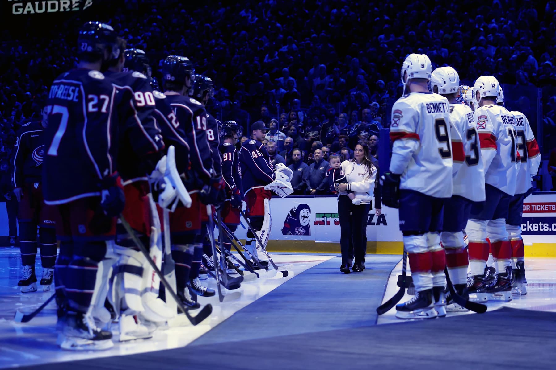 COLUMBUS, OHIO - OCTOBER 15: Meredith Gaudreau, the wife of former Columbus Blue Jackets player Johnny Gaudreau, walks out onto the ice while carrying her child for remembrance ceremony prior to the start of the game between the Columbus Blue Jackets and the Florida Panthers at Nationwide Arena on October 15, 2024 in Columbus, Ohio. Gaudreau, who along with his brother Matthew, was killed by a suspected drunk driver on August 29, 2024. (Photo by Kirk Irwin/NHLI via Getty Images)