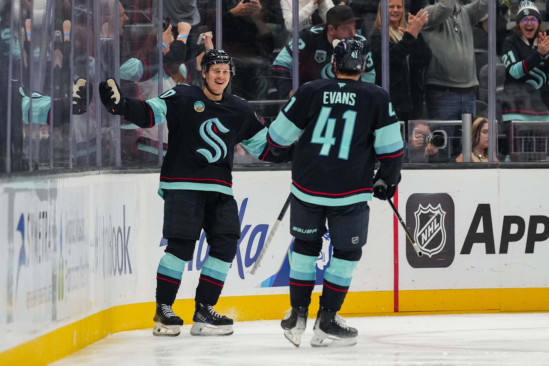 SEATTLE, WASHINGTON - OCTOBER 08: Eeli Tolvanen #20 and Ryker Evans #41 of the Seattle Kraken celebrate after scoring a goal during the second period of a game against the St. Louis Blues at Climate Pledge Arena on October 8, 2024 in Seattle, Washington. (Photo by Christopher Mast/NHLI via Getty Images)