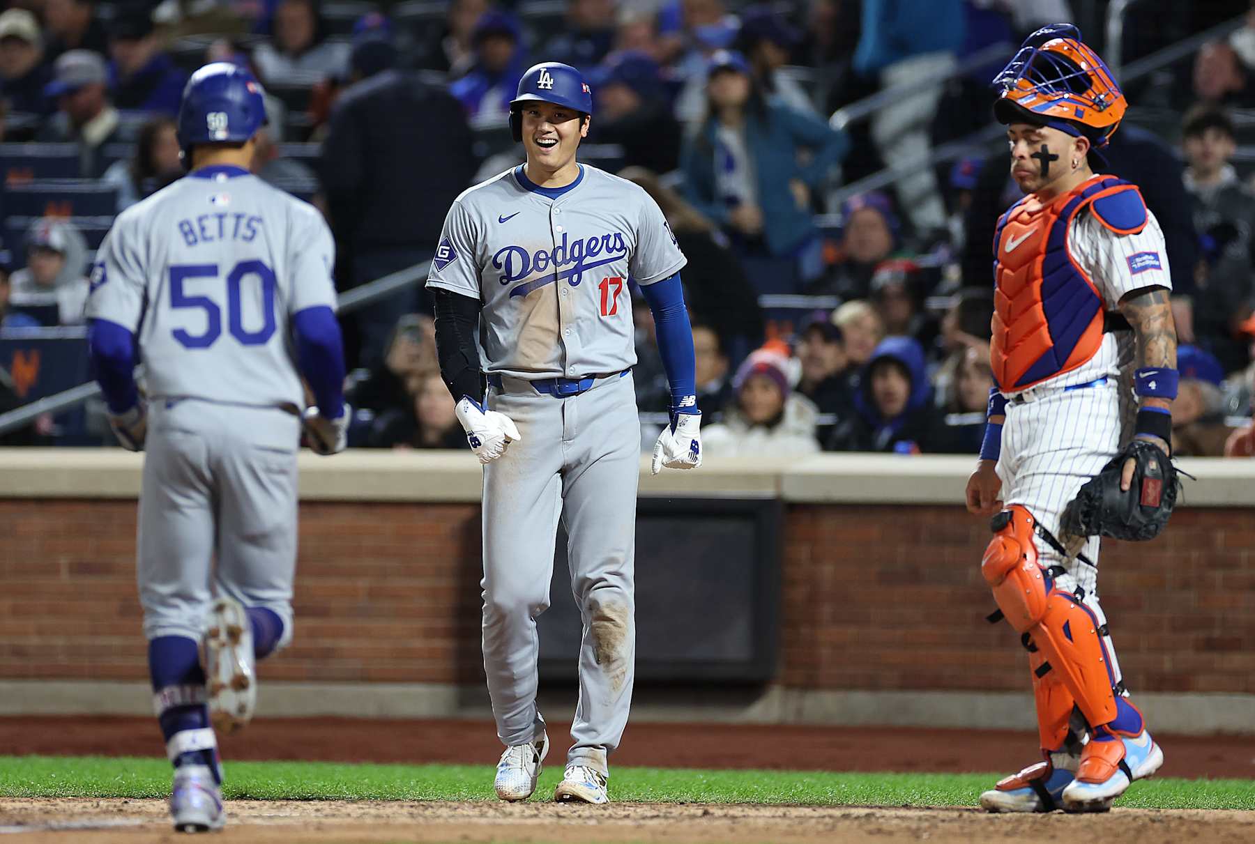 NEW YORK, NEW YORK - OCTOBER 17: Mookie Betts #50 of the Los Angeles Dodgers celebrates a two run home run with Shohei Ohtani #17 of the Los Angeles Dodgers as Francisco Alvarez #4 of the New York Mets reacts during the sixth inning against the New York Mets during Game Four of the National League Championship Series at Citi Field on October 17, 2024 in New York City. (Photo by Sarah Stier/Getty Images)