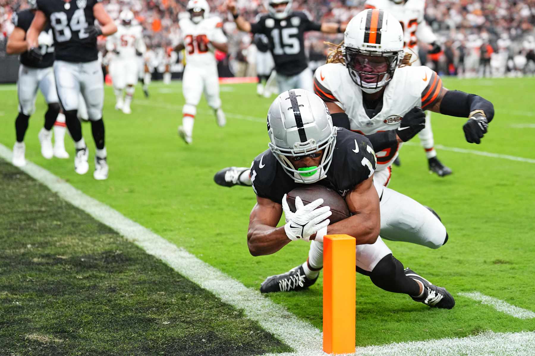LAS VEGAS, NEVADA - SEPTEMBER 29: Tre Tucker #11 of the Las Vegas Raiders scores a touchdown past Ronnie Hickman #33 of the Cleveland Browns in the second quarter at Allegiant Stadium on September 29, 2024 in Las Vegas, Nevada. (Photo by Jeff Bottari/Getty Images)