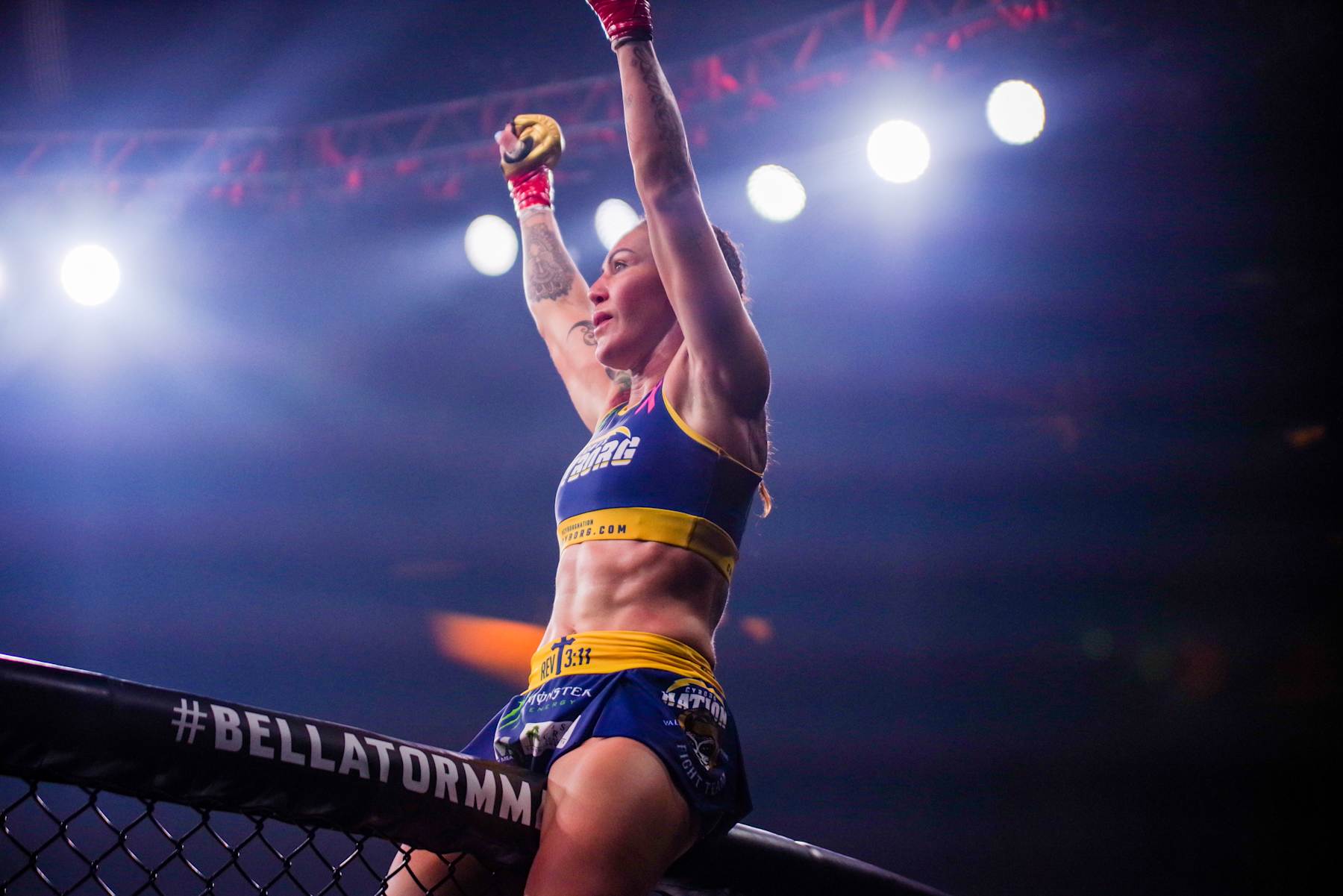 Cris Cyborg celebrates after defending her Bellator Featherweight Title