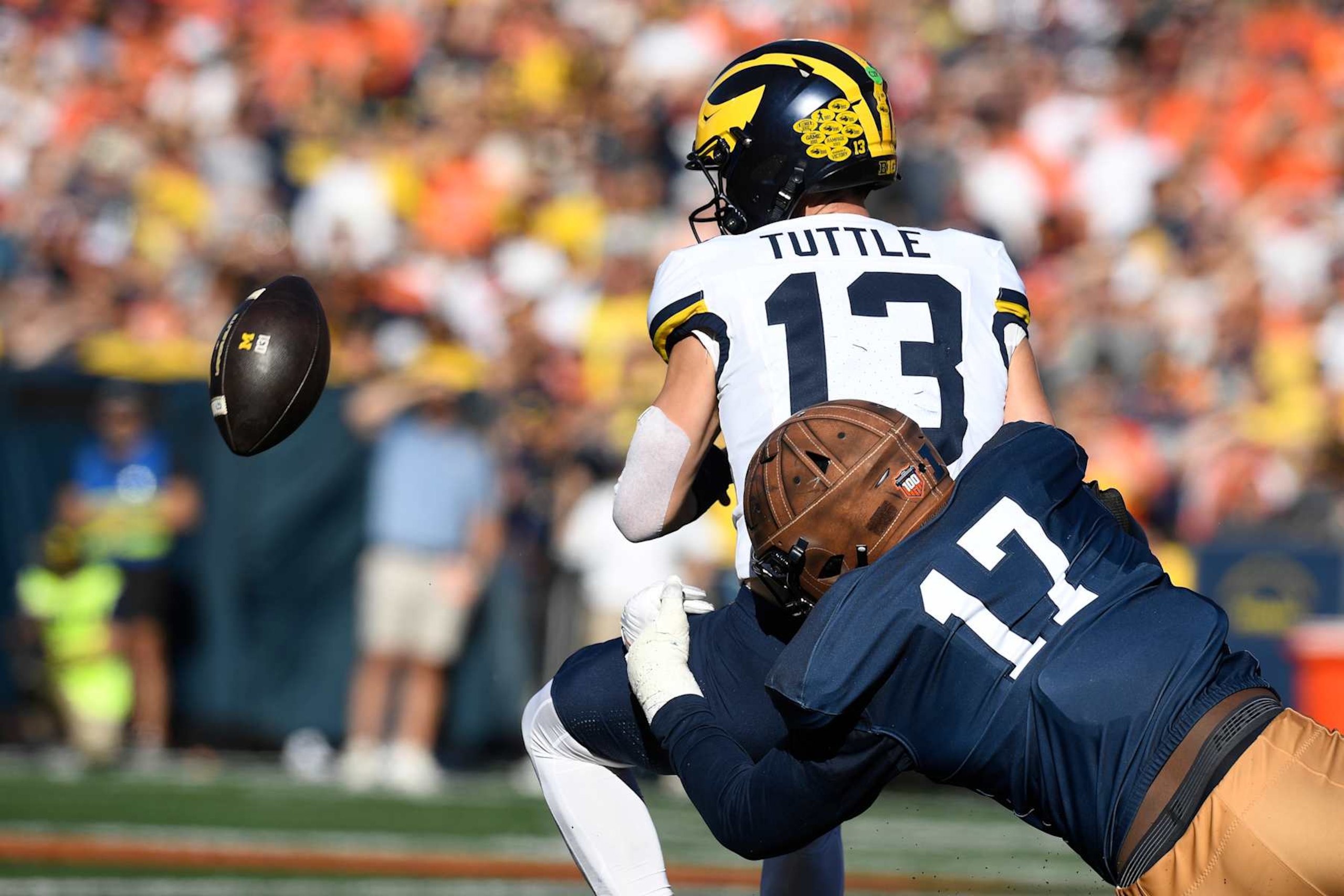 CHAMPAIGN, IL - OCTOBER 19: Michigan Wolverines Quarterback Jack Tuttle (13) fumbles the ball during the college football game between the Michigan Wolverines and the Illinois Fighting Illini on October 19, 2024, at Memorial Stadium, in Champaign, Illinois. (Photo by Michael Allio/Icon Sportswire via Getty Images)