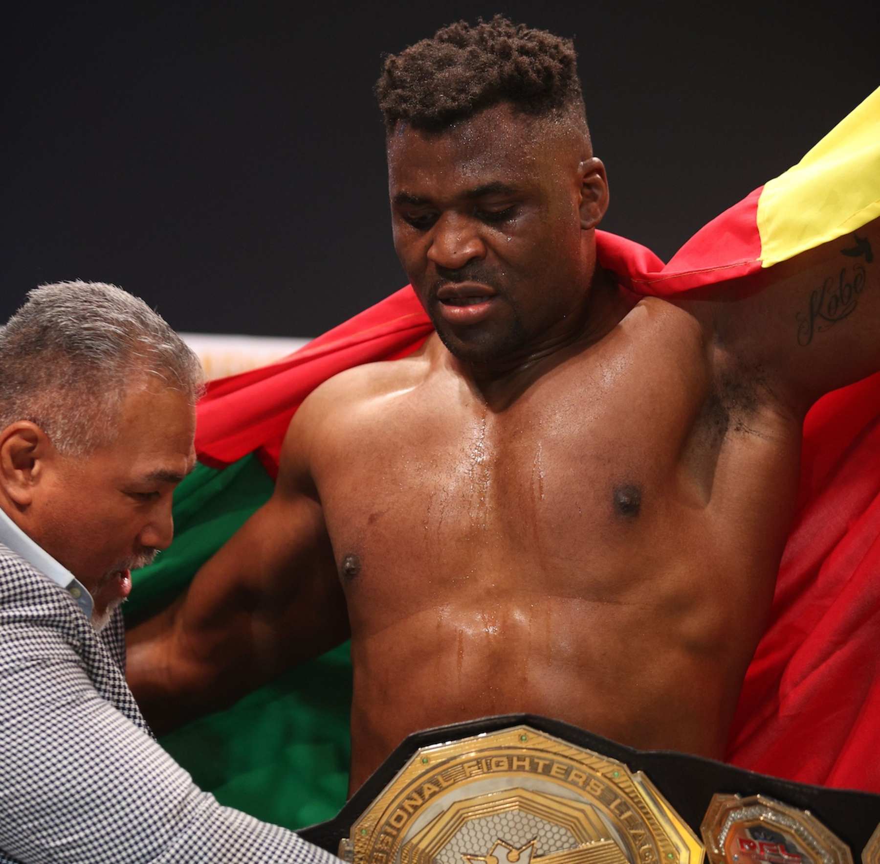Ray Sefo wraps the PFL Super Fights belt around Francis Ngannou's waist.