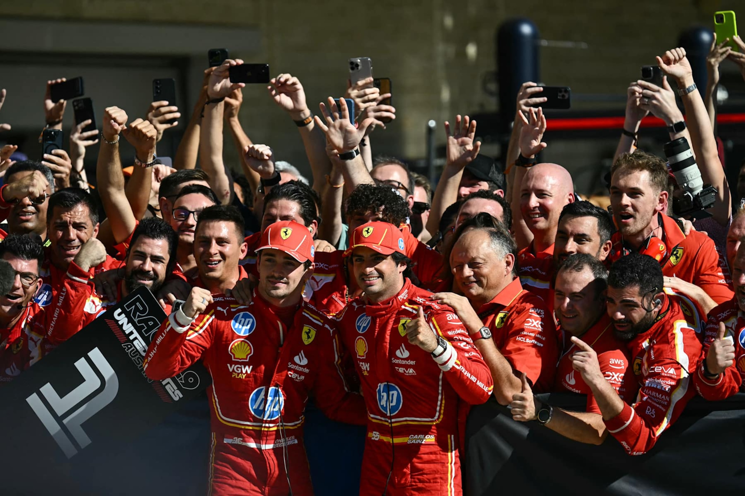 (At center, L-R) Ferrari's Monegasque driver Charles Leclerc, Ferrari's Spanish driver Carlos Sainz Jr. and Ferrari's French team principal Frédéric Vasseur celebrate with teammates after Leclerc won the United States Formula One Grand Prix at the Circuit of the Americas in Austin, Texas, on October 20, 2024. (Photo by Patrick T. Fallon / AFP) (Photo by PATRICK T. FALLON/AFP via Getty Images)