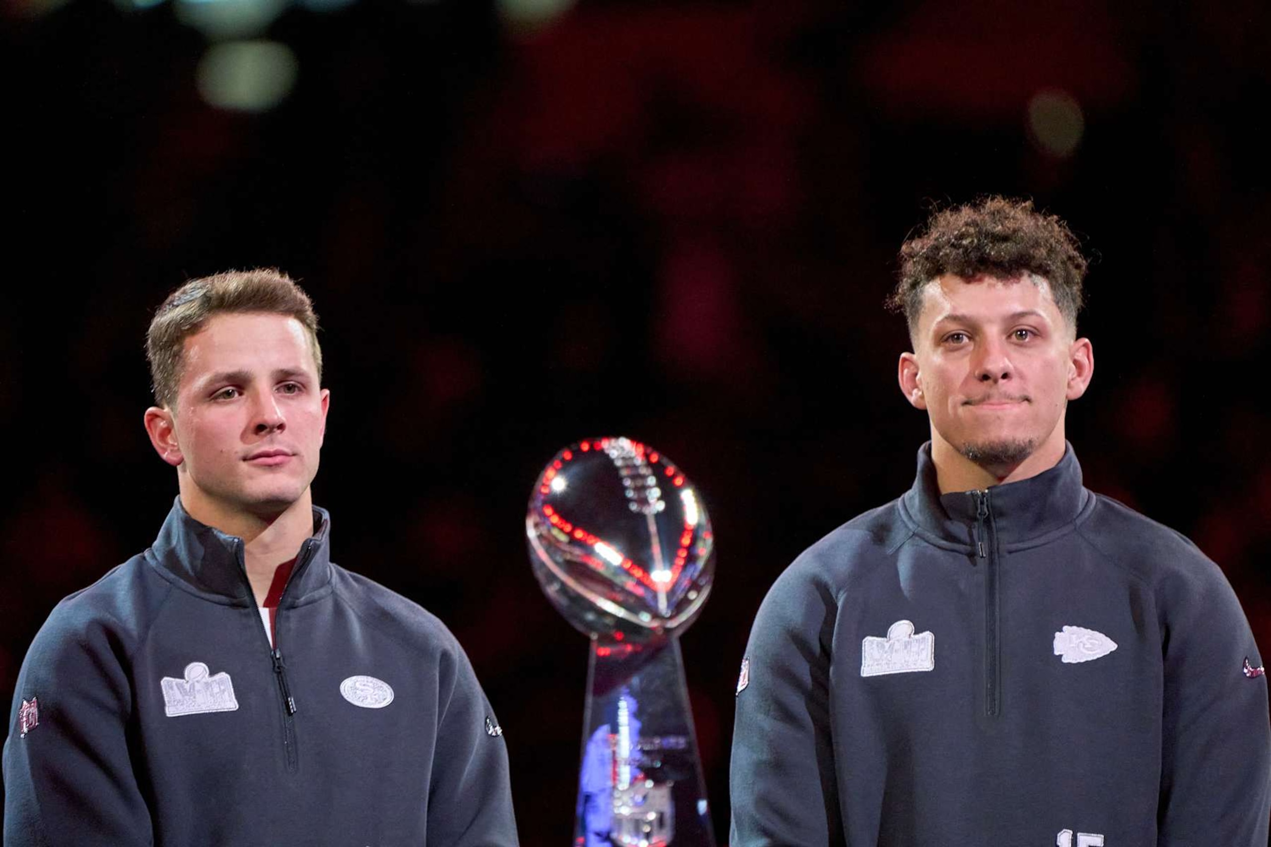 LAS VEGAS, NEVADA - FEBRUARY 5: Brock Purdy of the San Francisco 49ers (L) and Patrick Mahomes of the Kansas City Chiefs (R) stand on stage behind the Vince Lombardi Trophy during Super Bowl LVIII Opening Night at Allegiant Stadium on February 05, 2024 in Las Vegas, Nevada. (Photo by Robin Alam/ISI Photos/Getty Images)