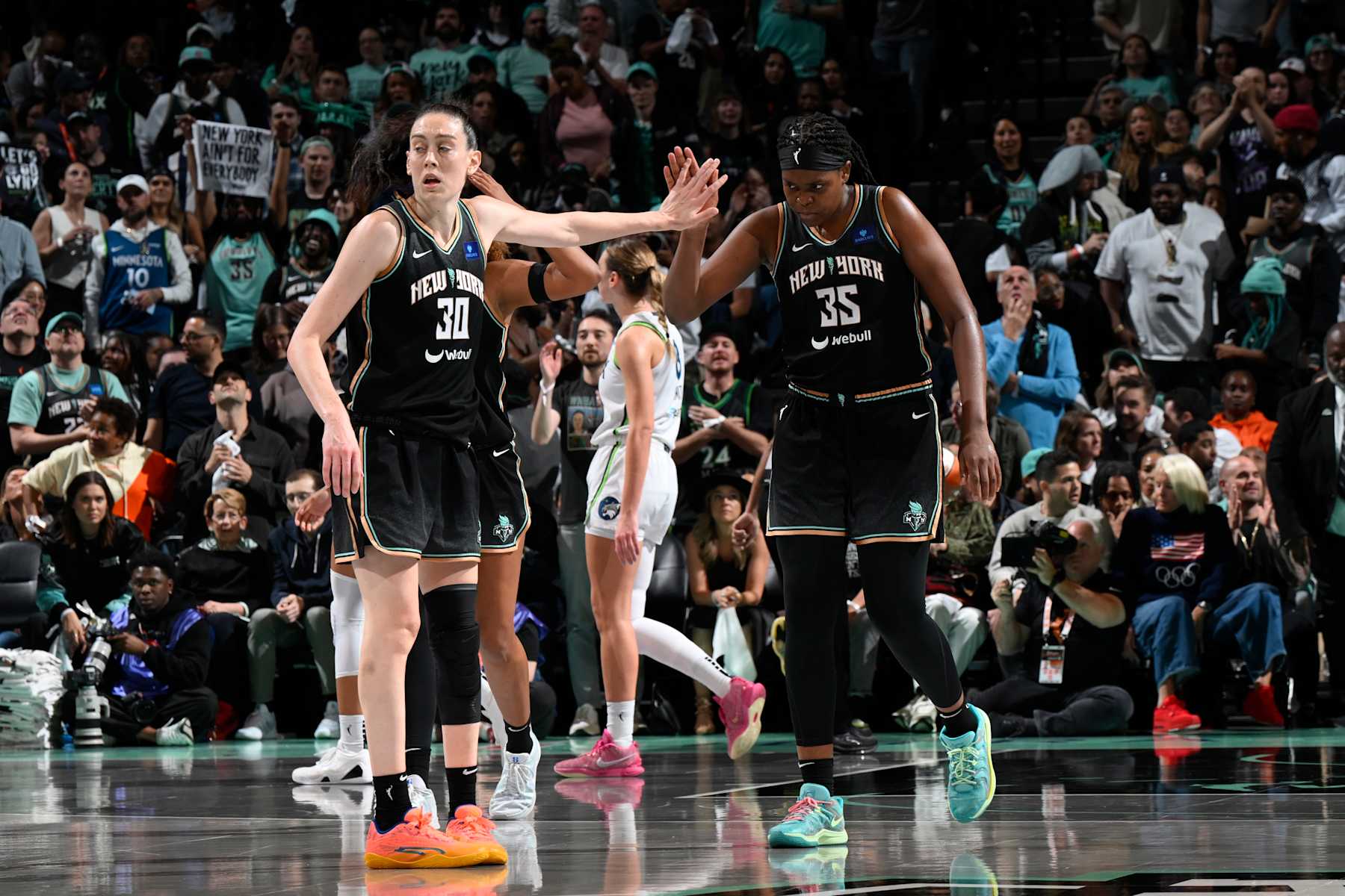 BROOKLYN, NY - OCTOBER 20: Breanna Stewart #30 and Jonquel Jones #35 of the New York Liberty high five during the game against the Minnesota Lynx during Game 5 of the WNBA Finals on October 20, 2024 in Brooklyn, New York. NOTE TO USER: User expressly acknowledges and agrees that, by downloading and or using this photograph, user is consenting to the terms and conditions of the Getty Images License Agreement. Mandatory Copyright Notice: Copyright 2024 NBAE (Photo by David Dow/NBAE via Getty Images)