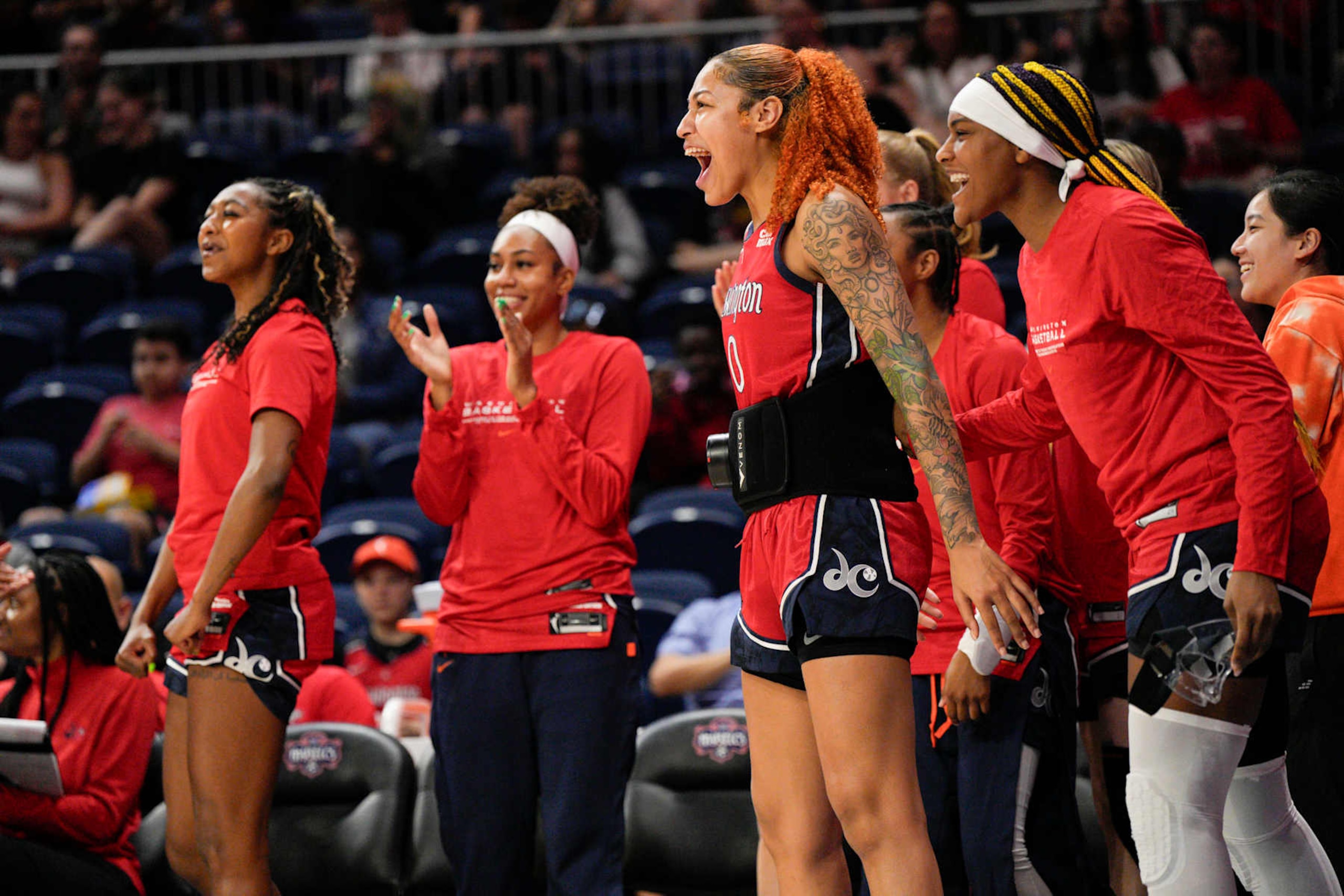 WASHINGTON, UNITED STATES - MAY 8: Washington Mystics center Shakira Austin (0) and forward Aaliyah Edwards (24) celebrate from the bench after the team scores against the Minnesota Lynx during the first half of the game at Entertainment and Sports Arena in Washington, DC, on May 08, 2024. (Photo by Jess Rapfogel for The Washington Post via Getty Images)