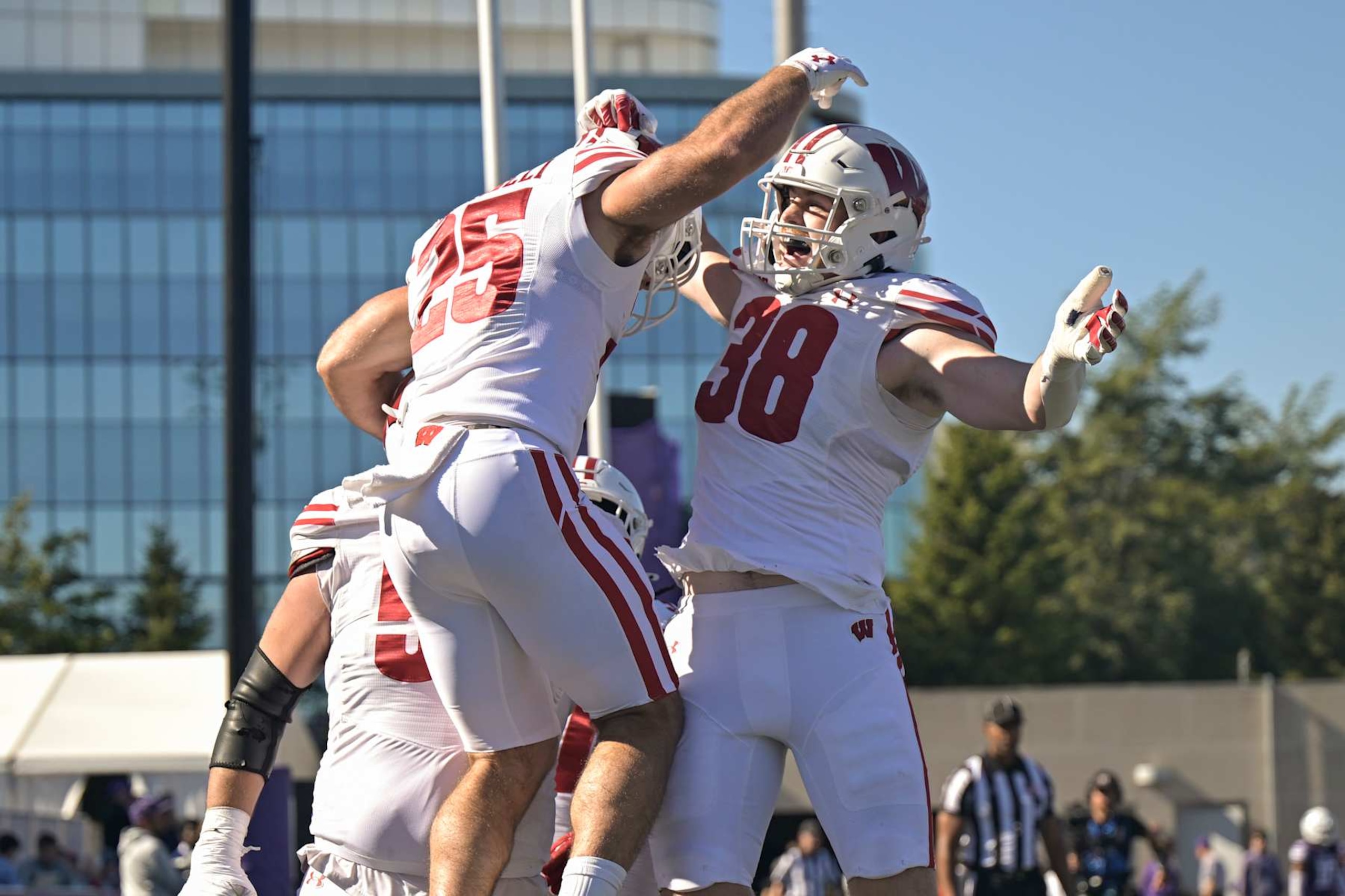 CHICAGO, ILLINOIS - OCTOBER 19: Cade Yacamelli #25 and Tucker Ashcraft #38 of the Wisconsin Badgers celebrate after a touchdown in the first half against the Northwestern Wildcats at Martin Stadium on October 19, 2024 in Chicago, Illinois. (Photo by Quinn Harris/Getty Images)