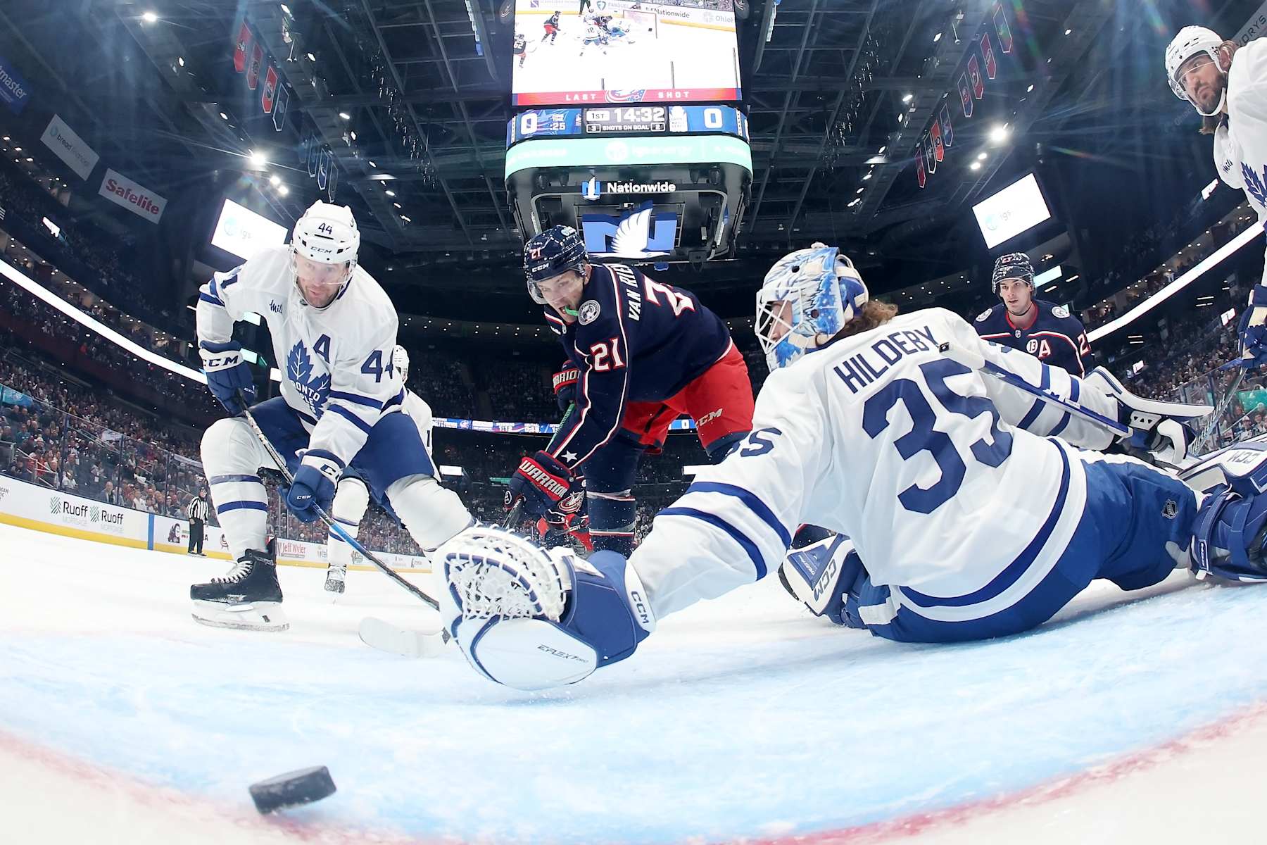 COLUMBUS, OHIO - OCTOBER 22: James van Riemsdyk #21 of the Columbus Blue Jackets flips the puck past Morgan Rielly #44 of the Toronto Maple Leafs and Dennis Hildeby #35 for a goal during the first period of the game at Nationwide Arena on October 22, 2024 in Columbus, Ohio. Columbus defeated Toronto 6-2. (Photo by Kirk Irwin/NHLI via Getty Images)