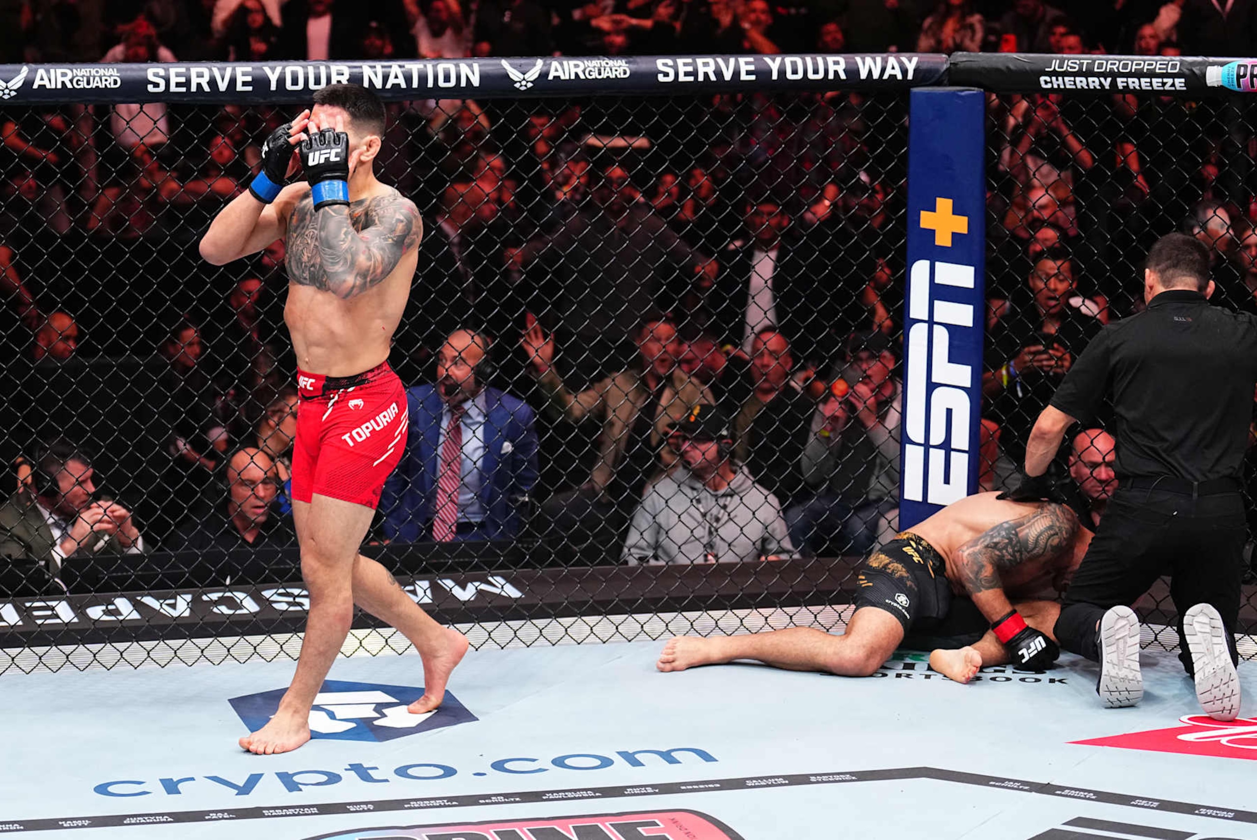 Ilia Topuria celebrates after his knockout victory against Alexander Volkanovski