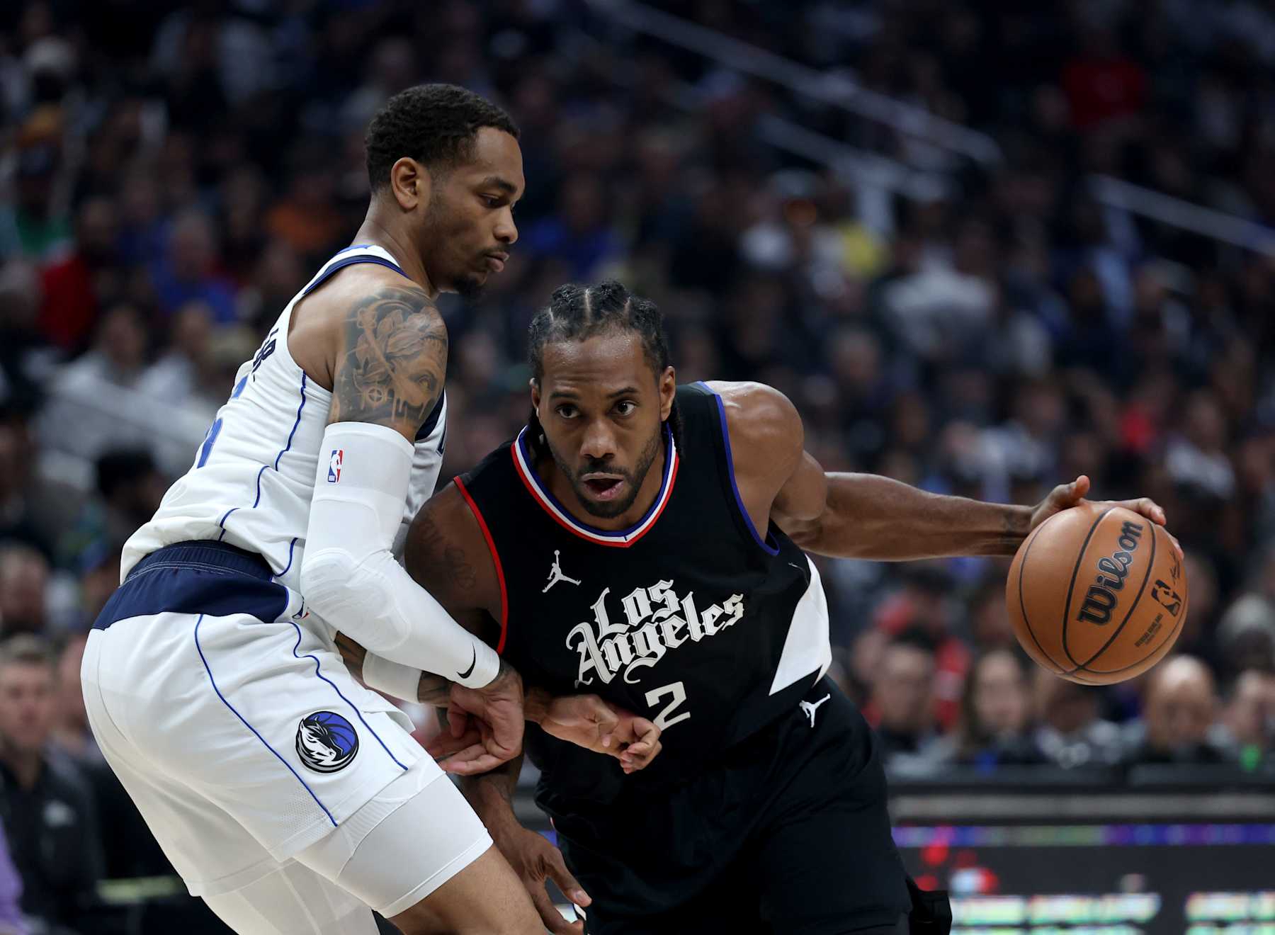 LOS ANGELES, CALIFORNIA - APRIL 23: Kawhi Leonard #2 of the LA Clippers drives to the basket on P.J. Washington #25 of the Dallas Mavericks during the first half at Crypto.com Arena on April 23, 2024 in Los Angeles, California. User is consenting to the terms and conditions of the Getty Images License Agreement. (Photo by Harry How/Getty Images)