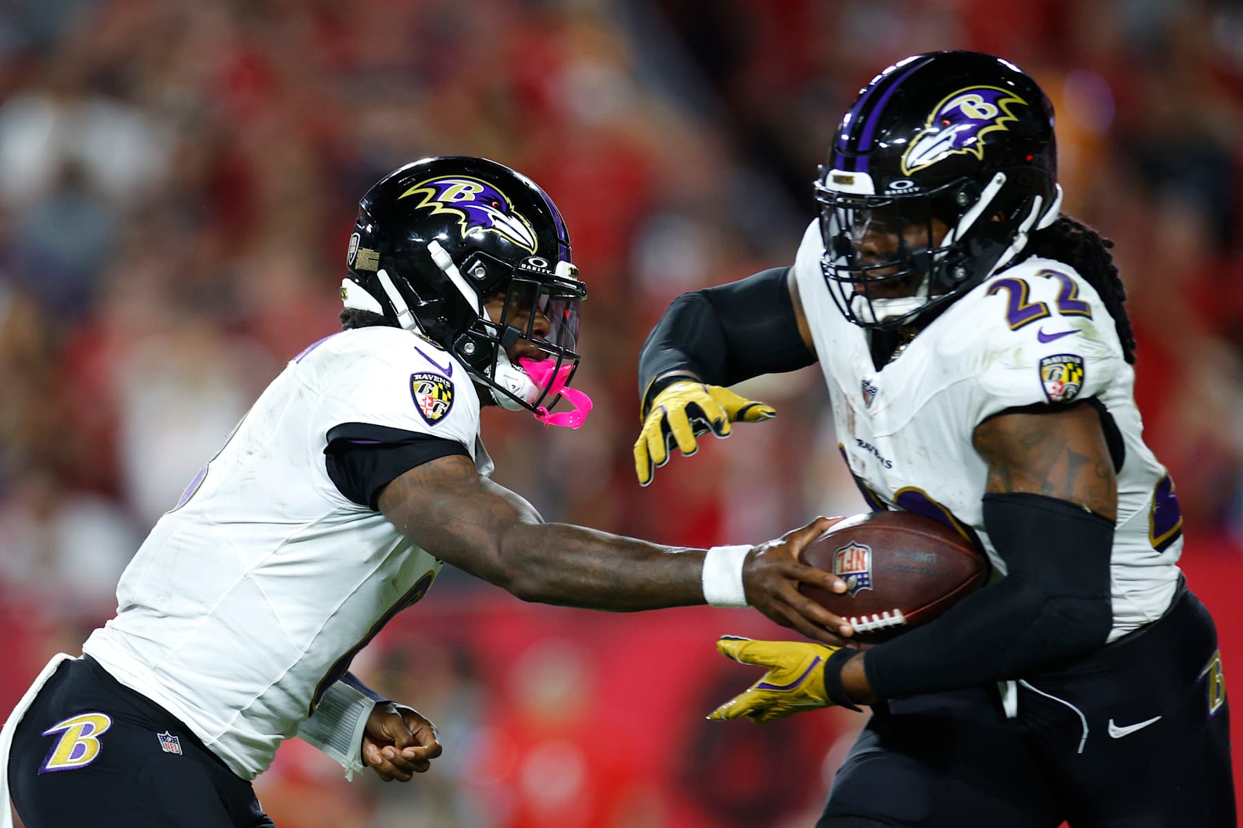 TAMPA, FLORIDA - OCTOBER 21: Lamar Jackson #8 of the Baltimore Ravens hands the ball to Derrick Henry #22 during the third quarter against the Tampa Bay Buccaneers at Raymond James Stadium on October 21, 2024 in Tampa, Florida. (Photo by Mike Ehrmann/Getty Images)