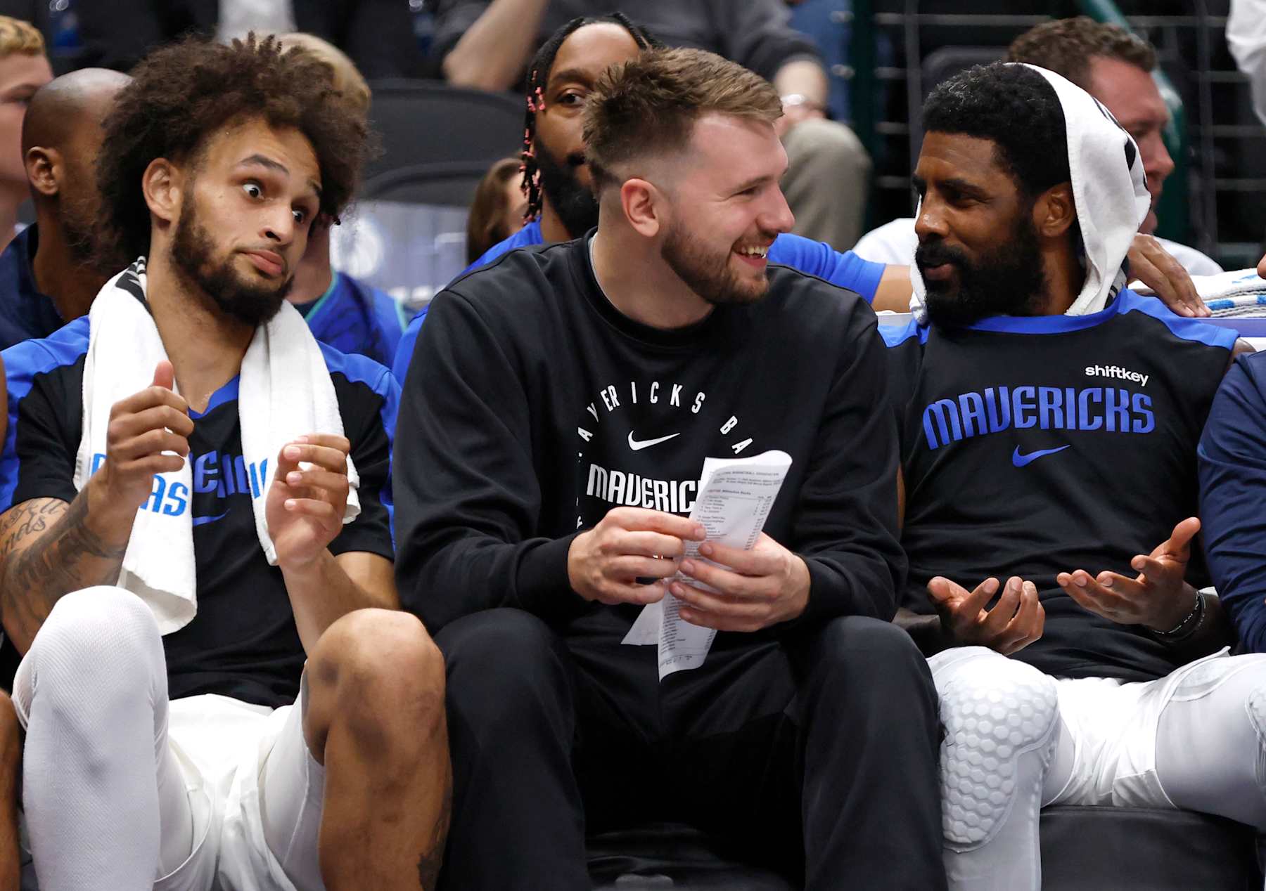 DALLAS, TX -OCTOBER 17: Luka Doncic #77 (C), Dereck Lively II #2 (L) and and Kyrie Irving #11 (R) of the Dallas Mavericks sit on the bench as the Dallas Mavericks take on the Milwaukee Bucks in the first half of an NBA preseason game at American Airlines Center on October 17, 2024 in Dallas, Texas. NOTE TO USER: User expressly acknowledges and agrees that, by downloading and or using this photograph, User is consenting to the terms and conditions of the Getty Images License Agreement. (Photo by Ron Jenkins/Getty Images)