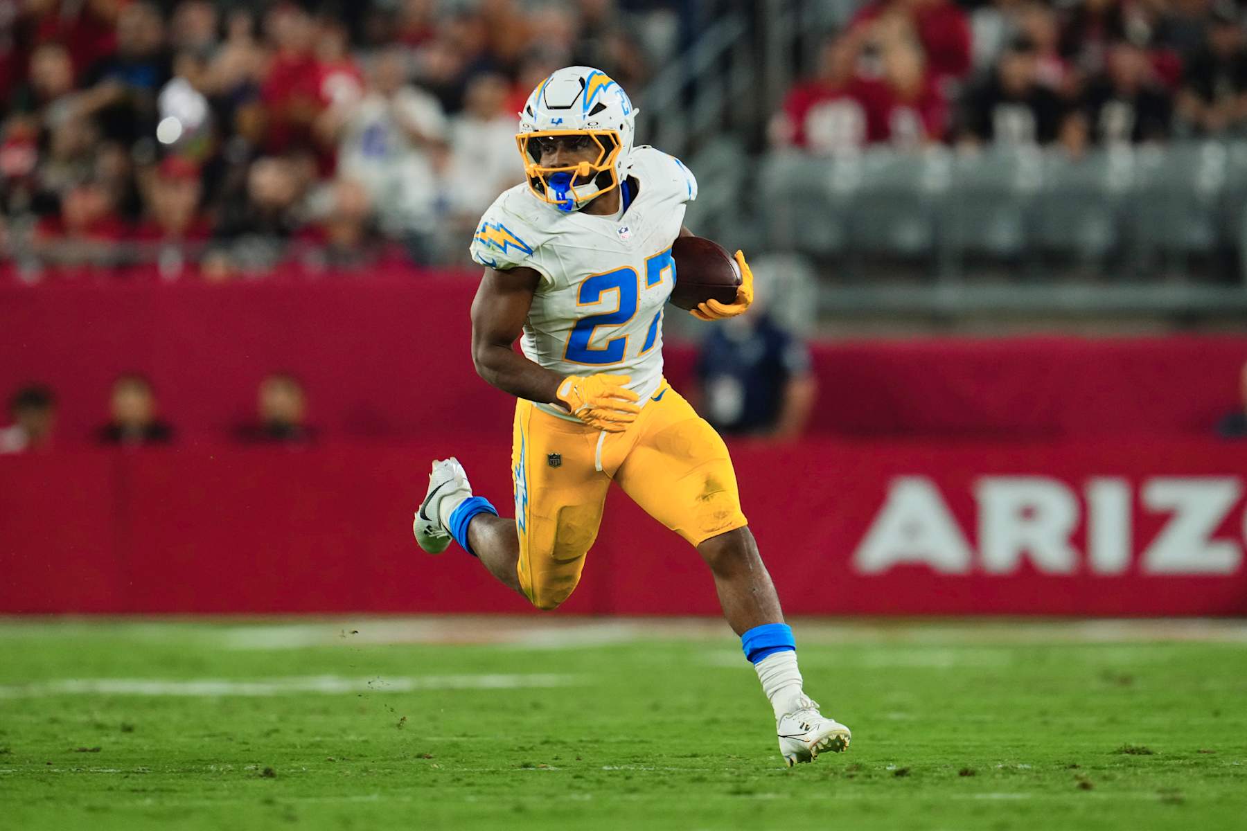 GLENDALE, AZ - OCTOBER 21: J.K. Dobbins #27 of the Los Angeles Chargers carries the ball against the Arizona Cardinals during the second half of an NFL football game at State Farm Stadium on October 21, 2024 in Glendale, Arizona. (Photo by Cooper Neill/Getty Images)