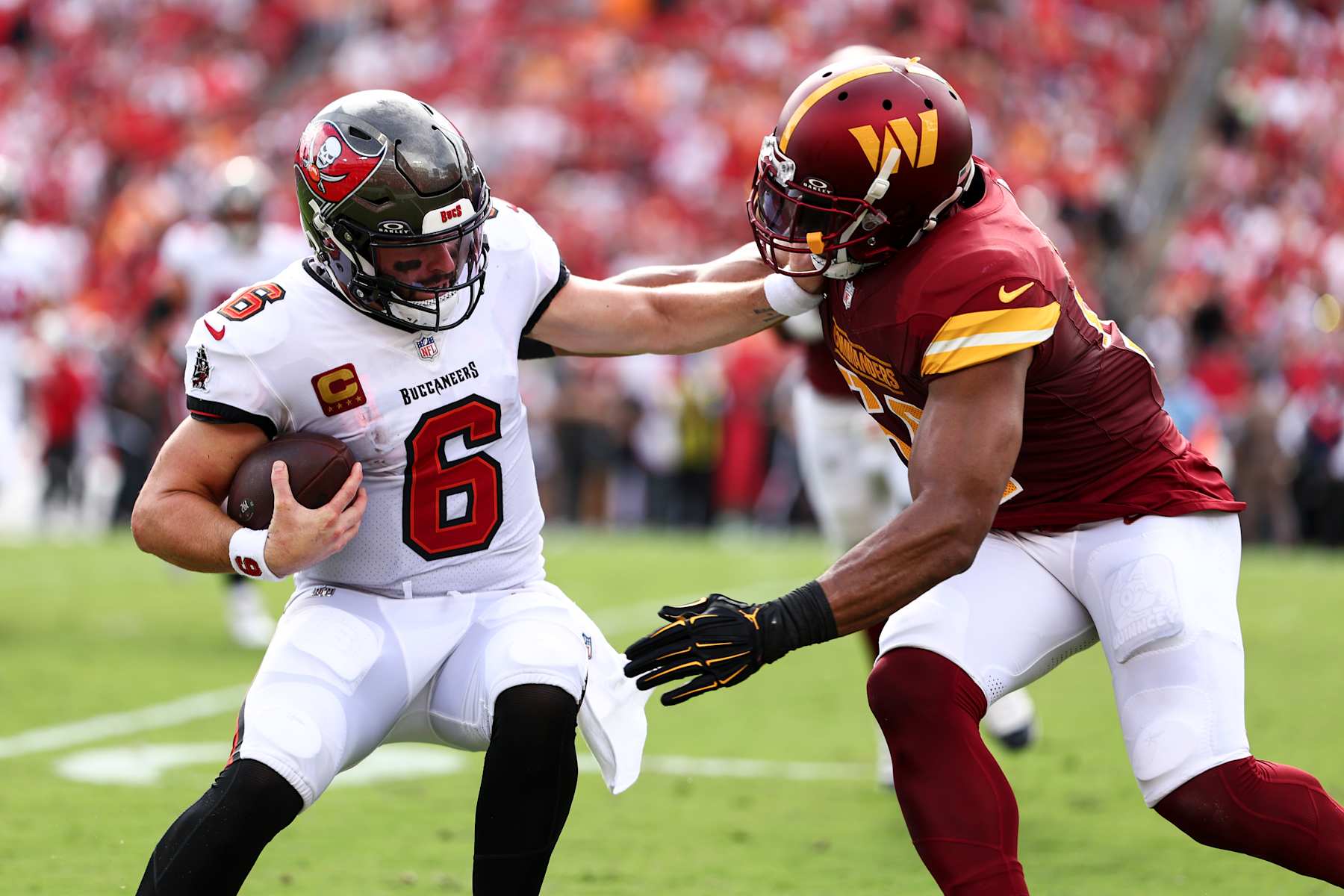 TAMPA, FL - SEPTEMBER 8: Baker Mayfield #6 of the Tampa Bay Buccaneers stiff arms Washington Commanders linebacker Bobby Wagner (54) during the first quarter of an NFL football game at Raymond James Stadium on September 8, 2024 in Tampa, Florida. (Photo by Kevin Sabitus/Getty Images)
