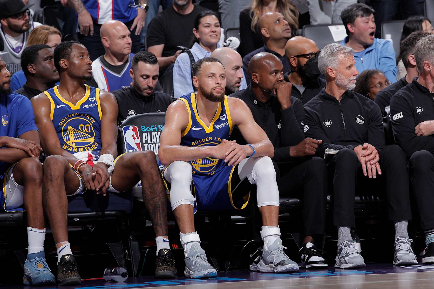 SACRAMENTO, CA - APRIL 16: Jonathan Kuminga #00 and Stephen Curry #30 of the Golden State Warriors look on from the bench during the game against the Sacramento Kings during the 2024 Play-In Tournament on April 16, 2024 at Golden 1 Center in Sacramento, California. NOTE TO USER: User expressly acknowledges and agrees that, by downloading and or using this photograph, User is consenting to the terms and conditions of the Getty Images Agreement. Mandatory Copyright Notice: Copyright 2024 NBAE (Photo by Rocky Widner/NBAE via Getty Images)