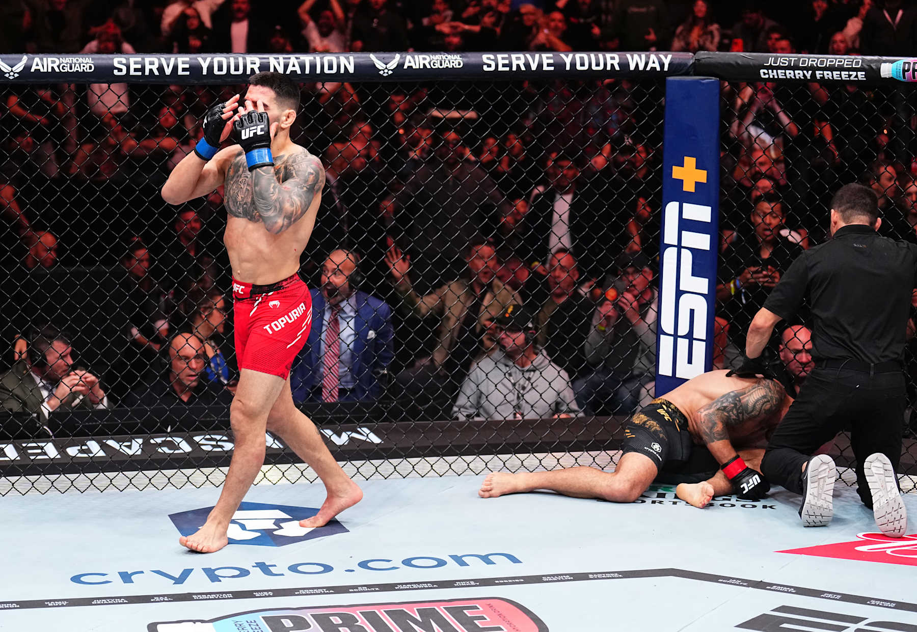 Ilia Topuria celebrates after his knockout victory against Alexander Volkanovski