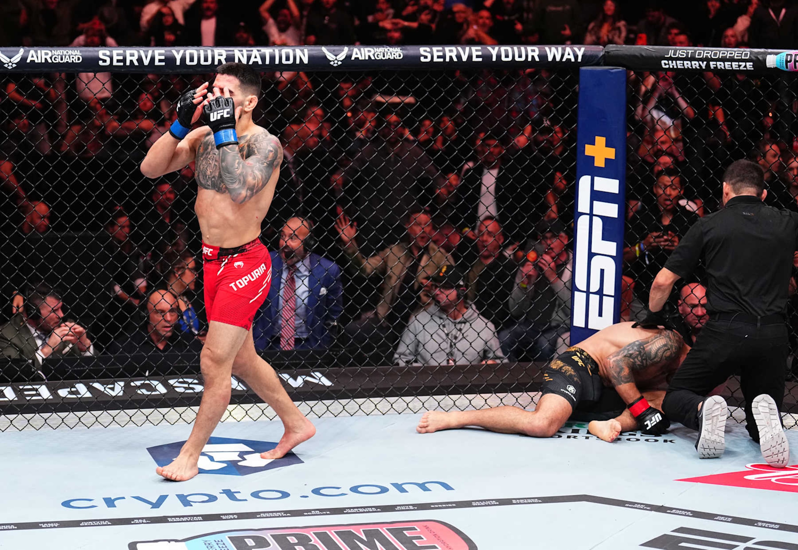 Ilia Topuria celebrates after his knockout victory against Alexander Volkanovski