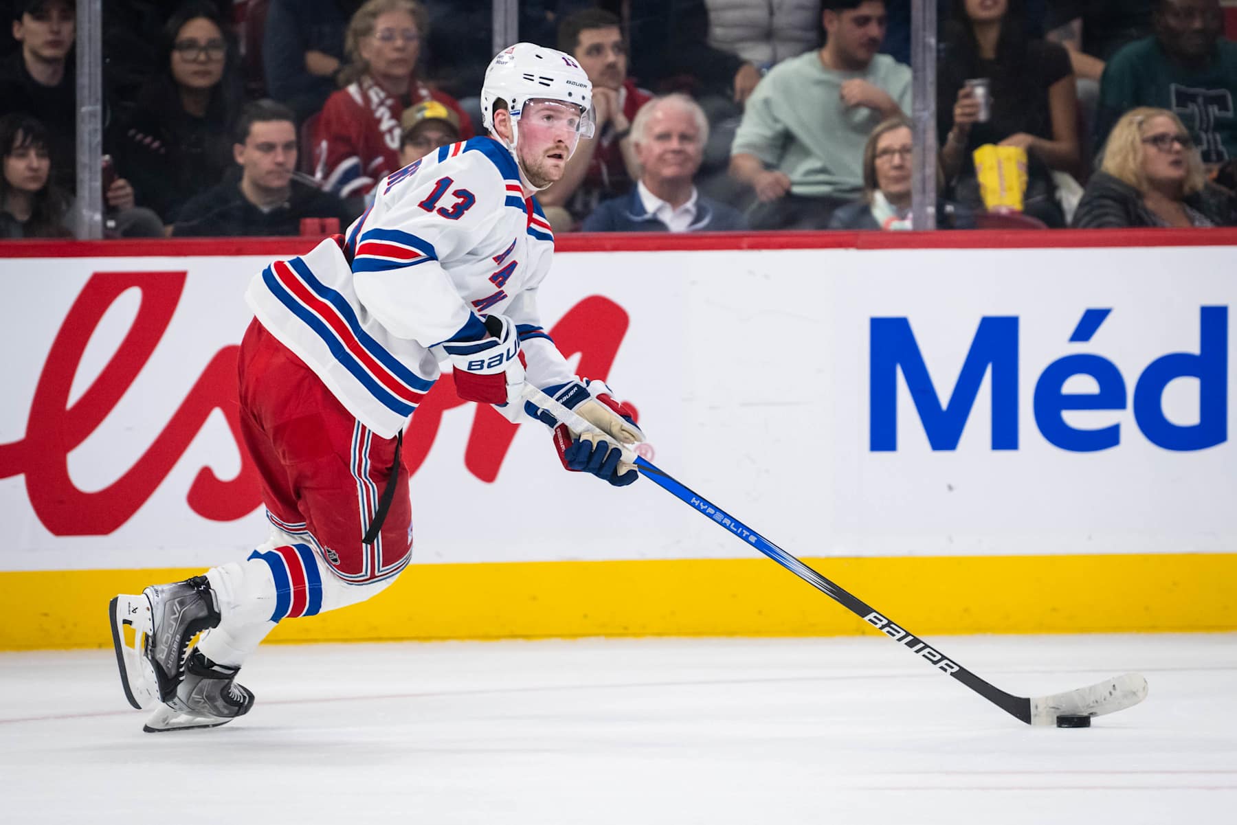 MONTREAL, QC - OCTOBER 22: Alexis Lafrenière (13) of the New York Rangers skates with the puck during the second period of the NHL game between the New York Rangers and the Montreal Canadiens on Oct 22, 2024, at the Bell Centre in Montreal, QC(Photo by Vincent Ethier/Icon Sportswire via Getty Images)
