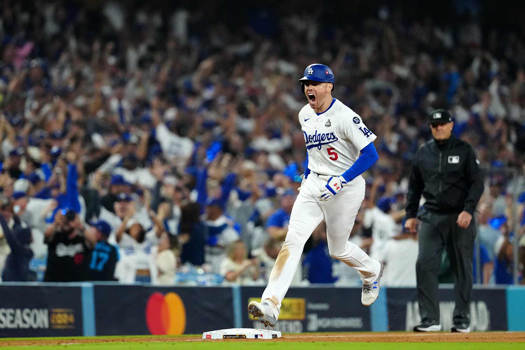 LOS ANGELES, CA - OCTOBER 25: Freddie Freeman #5 of the Los Angeles Dodgers celebrates after hitting a walk-off grand slam in the tenth inning during Game 1 of the 2024 World Series presented by Capital One between the New York Yankees and the Los Angeles Dodgers at Dodger Stadium on Friday, October 25, 2024 in Los Angeles, California. (Photo by Daniel Shirey/MLB Photos via Getty Images)