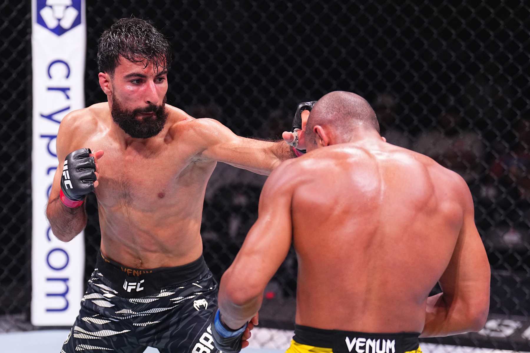 ABU DHABI, UNITED ARAB EMIRATES - OCTOBER 26: (L-R) Farid Basharat of Afghanistan punches Victor Hugo of Brazil in a bantamweight fight during the UFC 308 event at Etihad Arena on October 26, 2024 in Abu Dhabi, United Arab Emirates. (Photo by Chris Unger/Zuffa LLC)