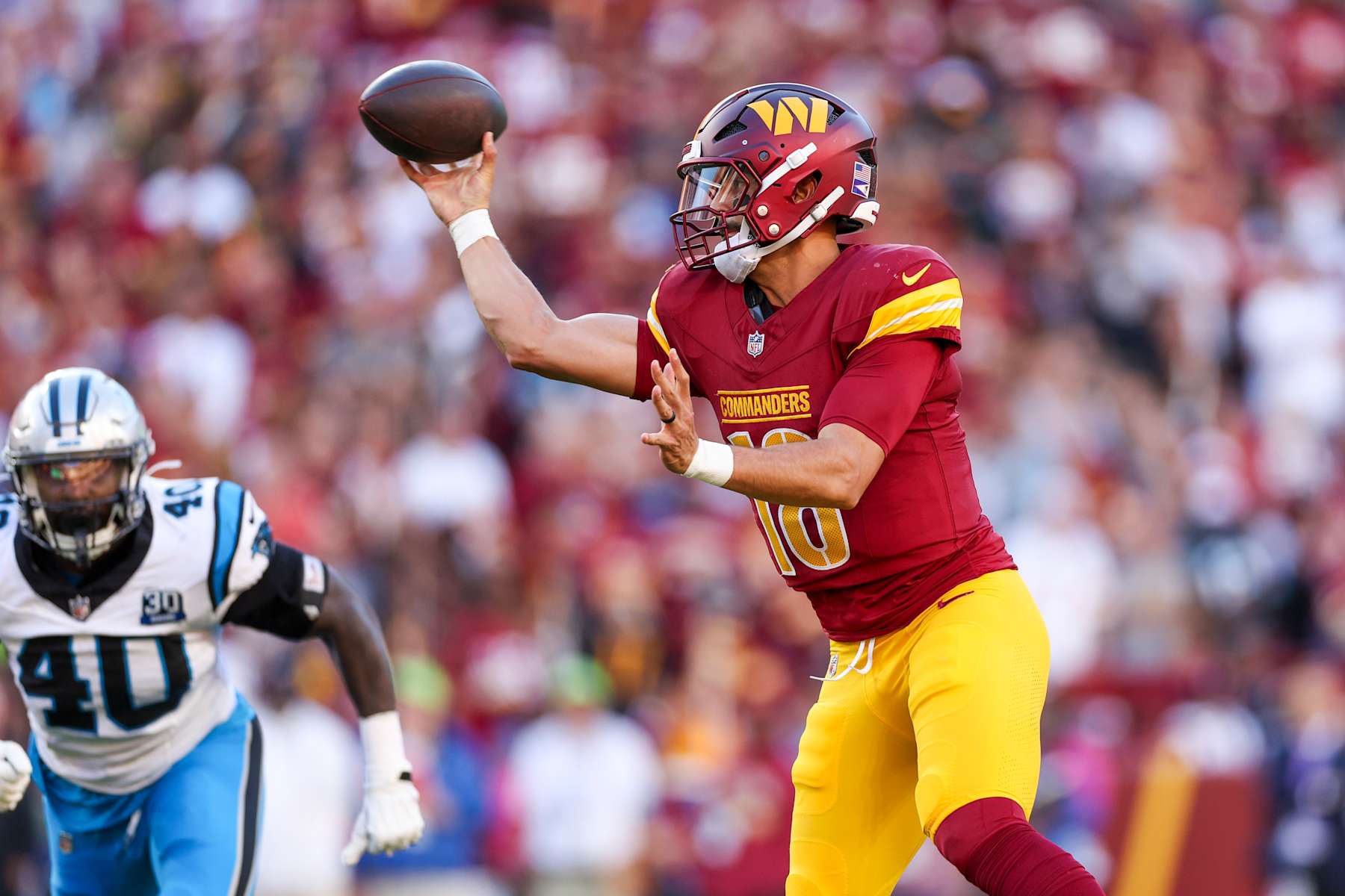 LANDOVER, MARYLAND - OCTOBER 20: Marcus Mariota #18 of the Washington Commanders throws a pass against the Carolina Panthers during the second quarter at Northwest Stadium on October 20, 2024 in Landover, Maryland. (Photo by Patrick Smith/Getty Images)