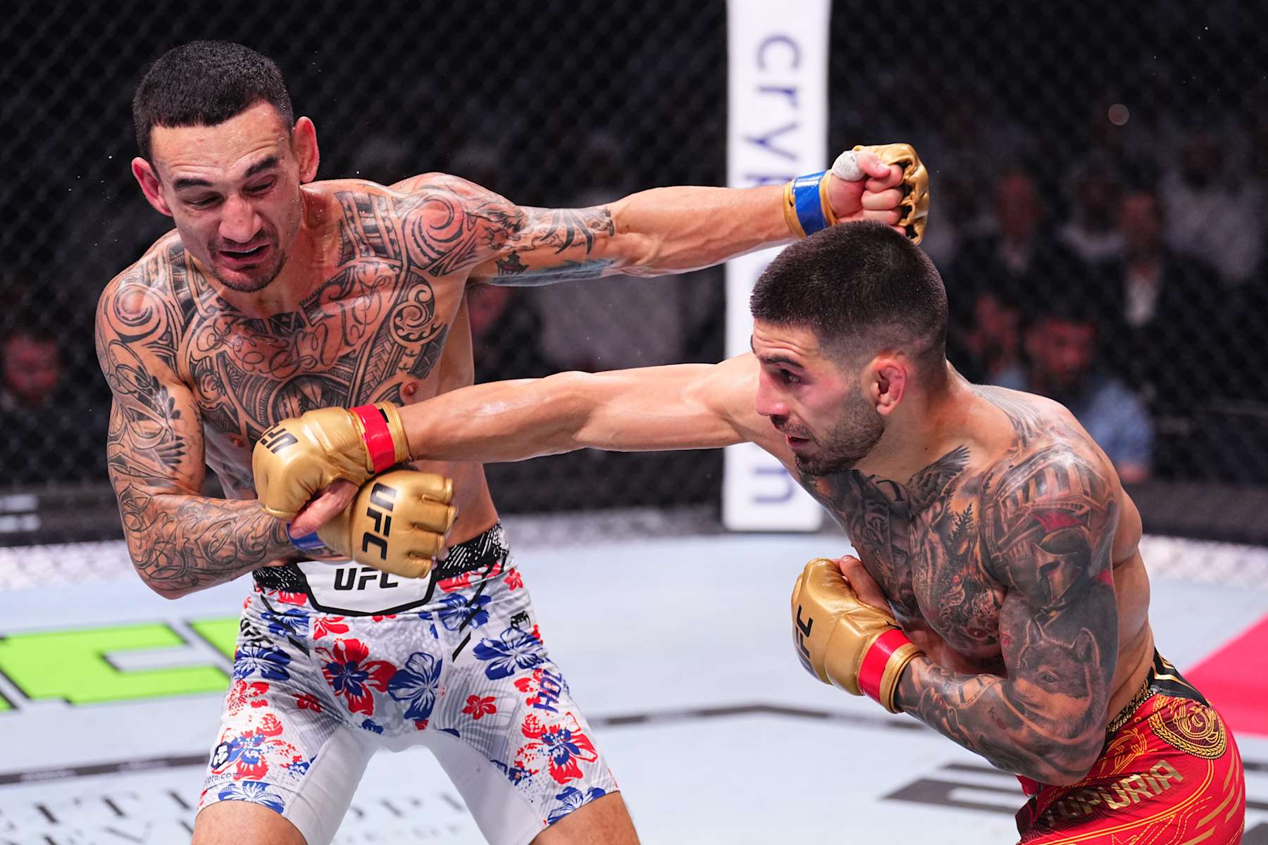 ABU DHABI, UNITED ARAB EMIRATES - OCTOBER 26: (R-L) Ilia Topuria of Spain punches Max Holloway in the UFC featherweight championship fight during the UFC 308 event at Etihad Arena on October 26, 2024 in Abu Dhabi, United Arab Emirates. (Photo by Chris Unger/Zuffa LLC)