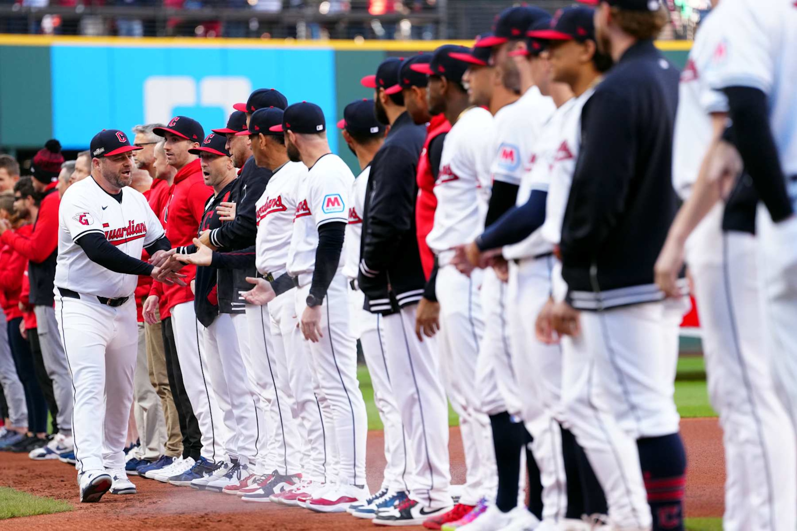 CLEVELAND, OH - OCTOBER 17:  Manager Stephen Vogt #12 of the Cleveland Guardians is greeted by players during the pre-game ceremony prior to Game 3 of the ALCS presented by loanDepot between the New York Yankees and the Cleveland Guardians at Progressive Field on Thursday, October 17, 2024 in Cleveland, Ohio. (Photo by Mary DeCicco/MLB Photos via Getty Images)