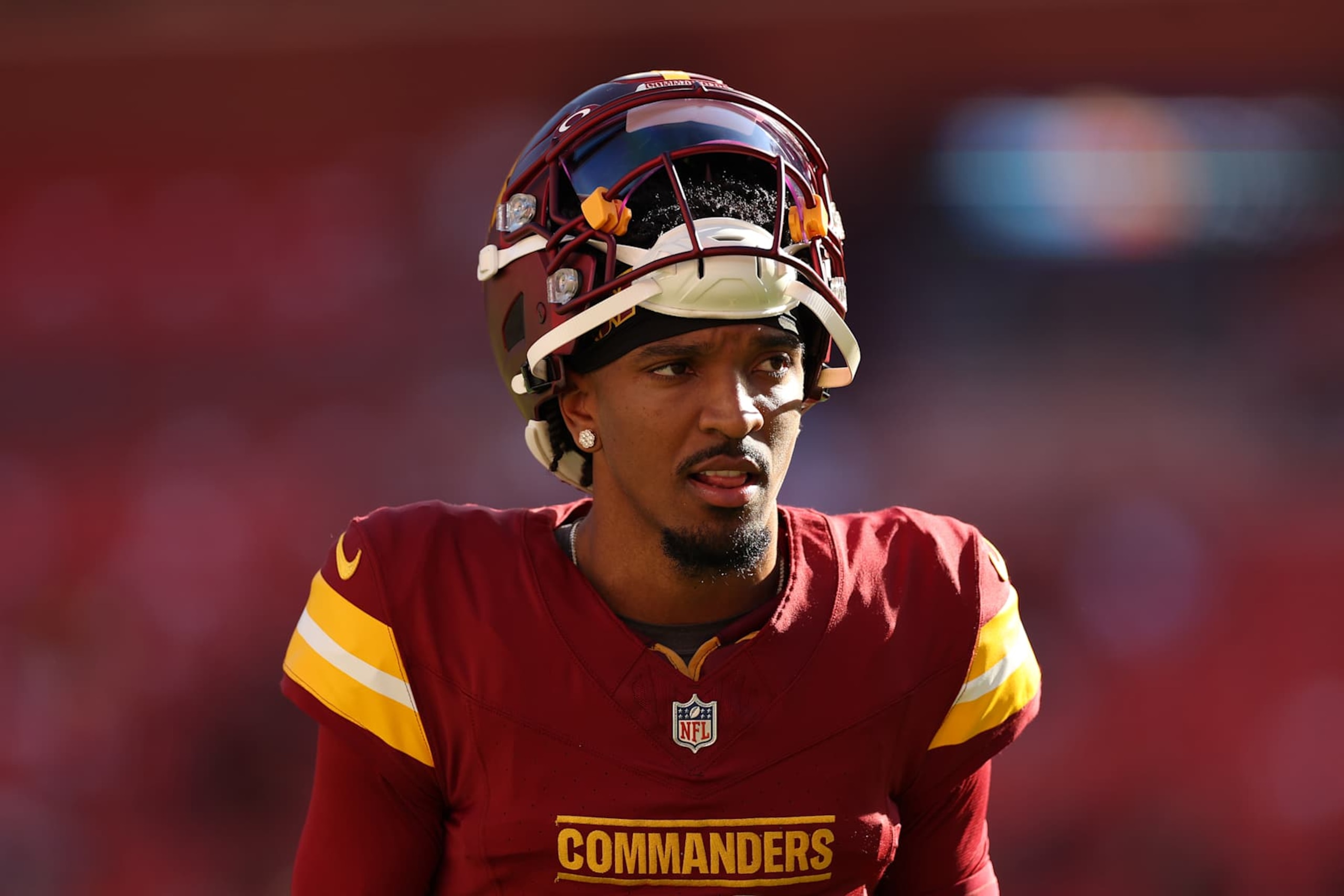 LANDOVER, MARYLAND - OCTOBER 20: Jayden Daniels #5 of the Washington Commanders looks on prior to the game against the Carolina Panthers at Northwest Field on October 20, 2024 in Landover, Maryland. (Photo by Patrick Smith/Getty Images)