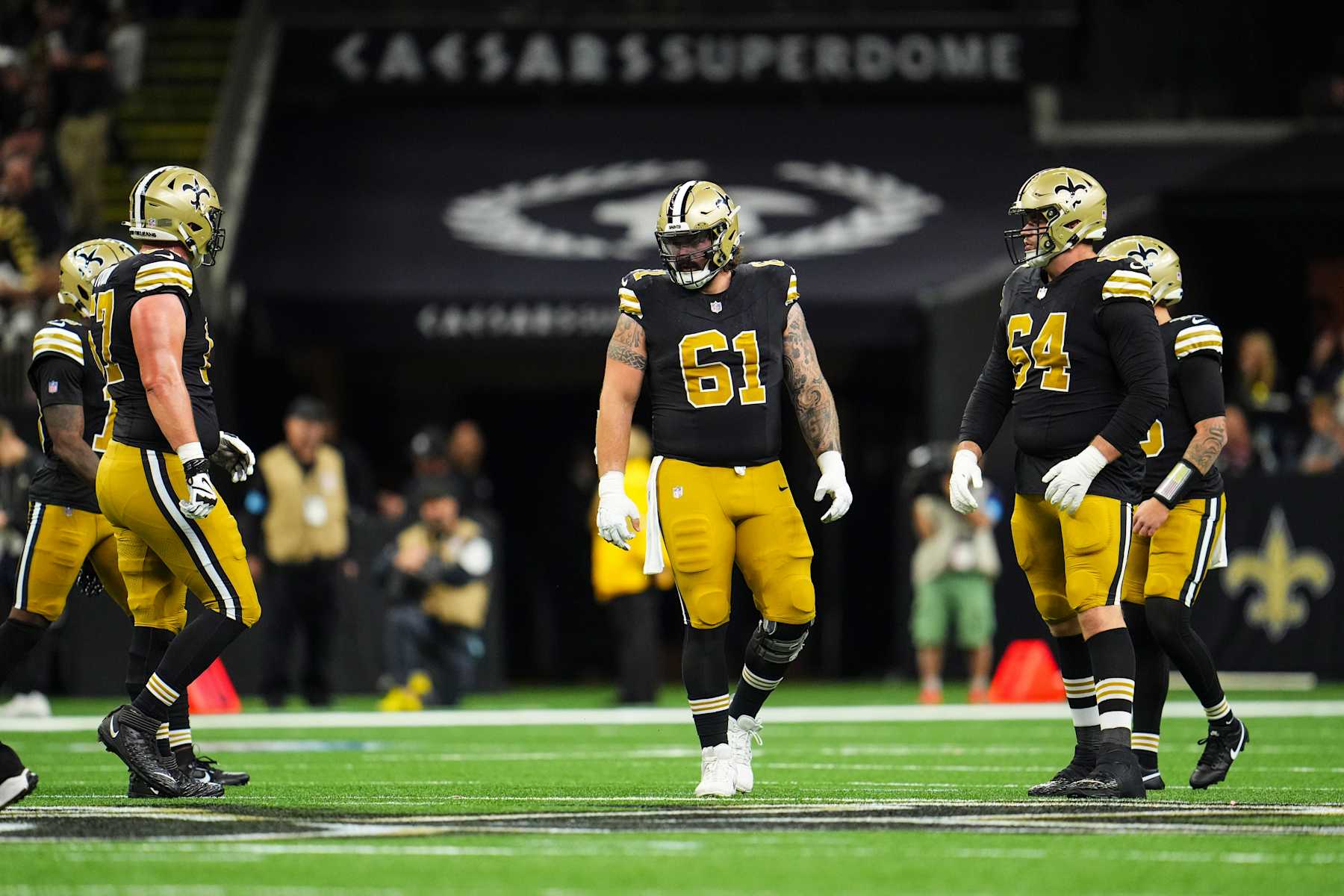 NEW ORLEANS, LA - OCTOBER 17: Connor McGovern #61 of the New Orleans Saints lines up before the snap during an NFL football game against the Denver Broncos at Caesars Superdome on October 17, 2024 in New Orleans, Louisiana. (Photo by Cooper Neill/Getty Images)