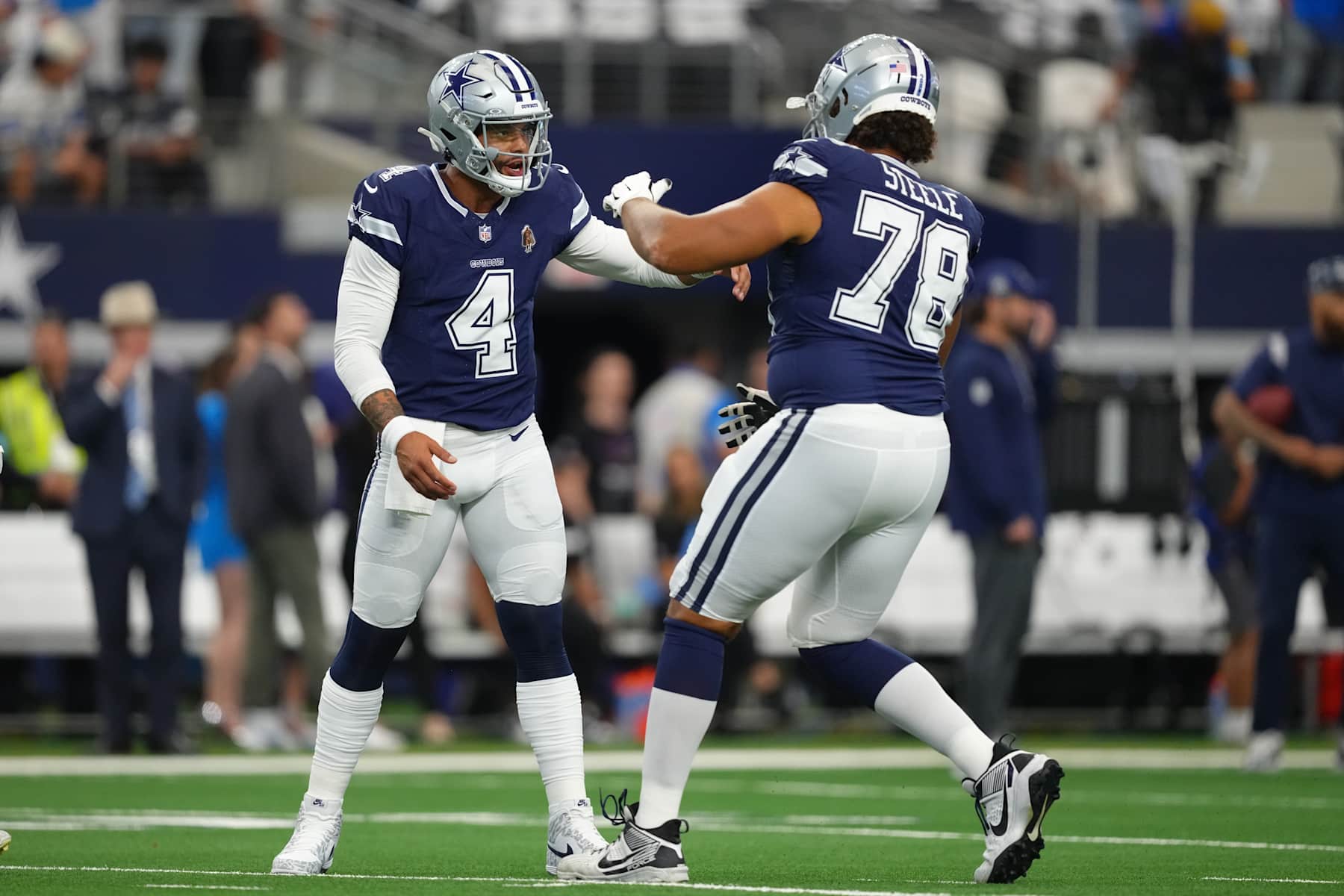 ARLINGTON, TEXAS - OCTOBER 13: Dak Prescott #4 of the Dallas Cowboys greets Terence Steele #78 on the field before a game \L at AT&T Stadium on October 13, 2024 in Arlington, Texas. (Photo by Sam Hodde/Getty Images)
