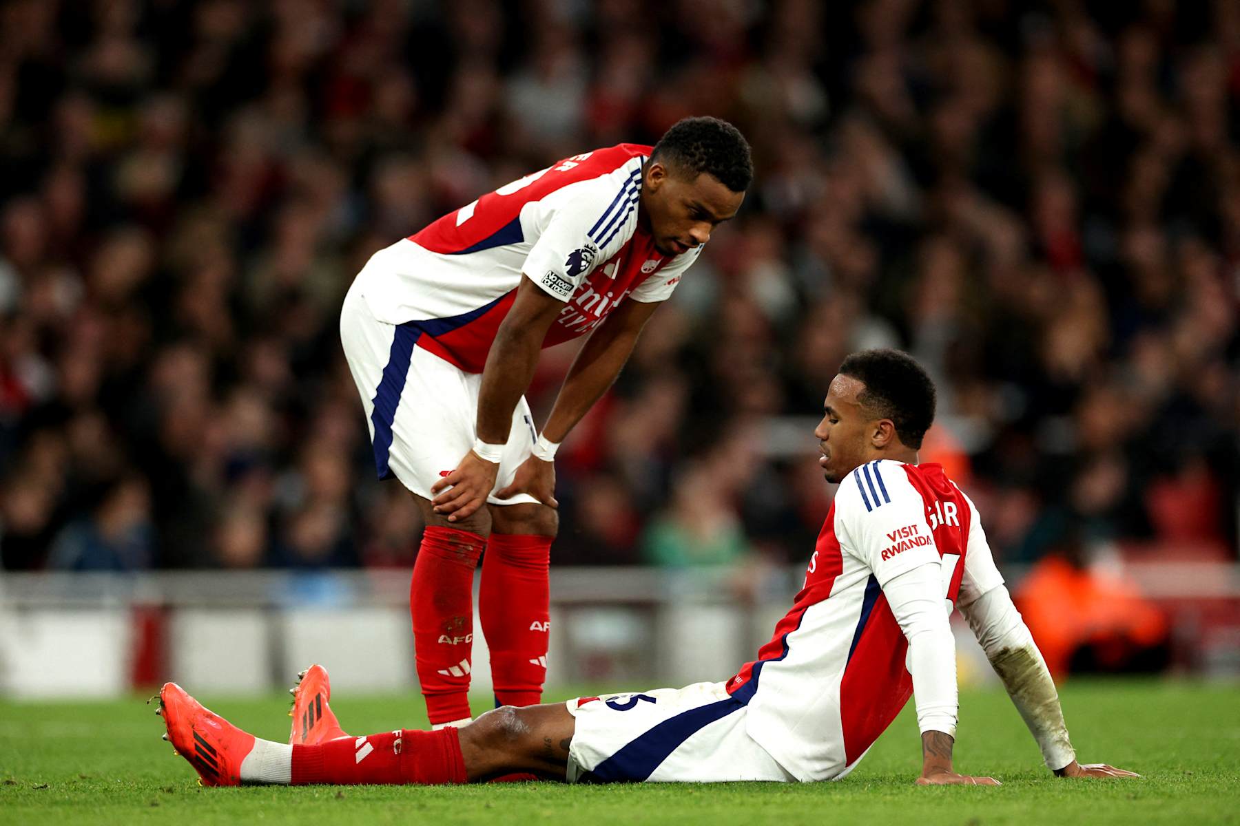 Arsenal's Brazilian defender #06 Gabriel Magalhaes sits on the floor injured during the English Premier League football match between Arsenal and Liverpool at the Emirates Stadium in London on October 27, 2024. (Photo by Adrian Dennis / AFP) / RESTRICTED TO EDITORIAL USE. No use with unauthorized audio, video, data, fixture lists, club/league logos or 'live' services. Online in-match use limited to 120 images. An additional 40 images may be used in extra time. No video emulation. Social media in-match use limited to 120 images. An additional 40 images may be used in extra time. No use in betting publications, games or single club/league/player publications. / (Photo by ADRIAN DENNIS/AFP via Getty Images)
