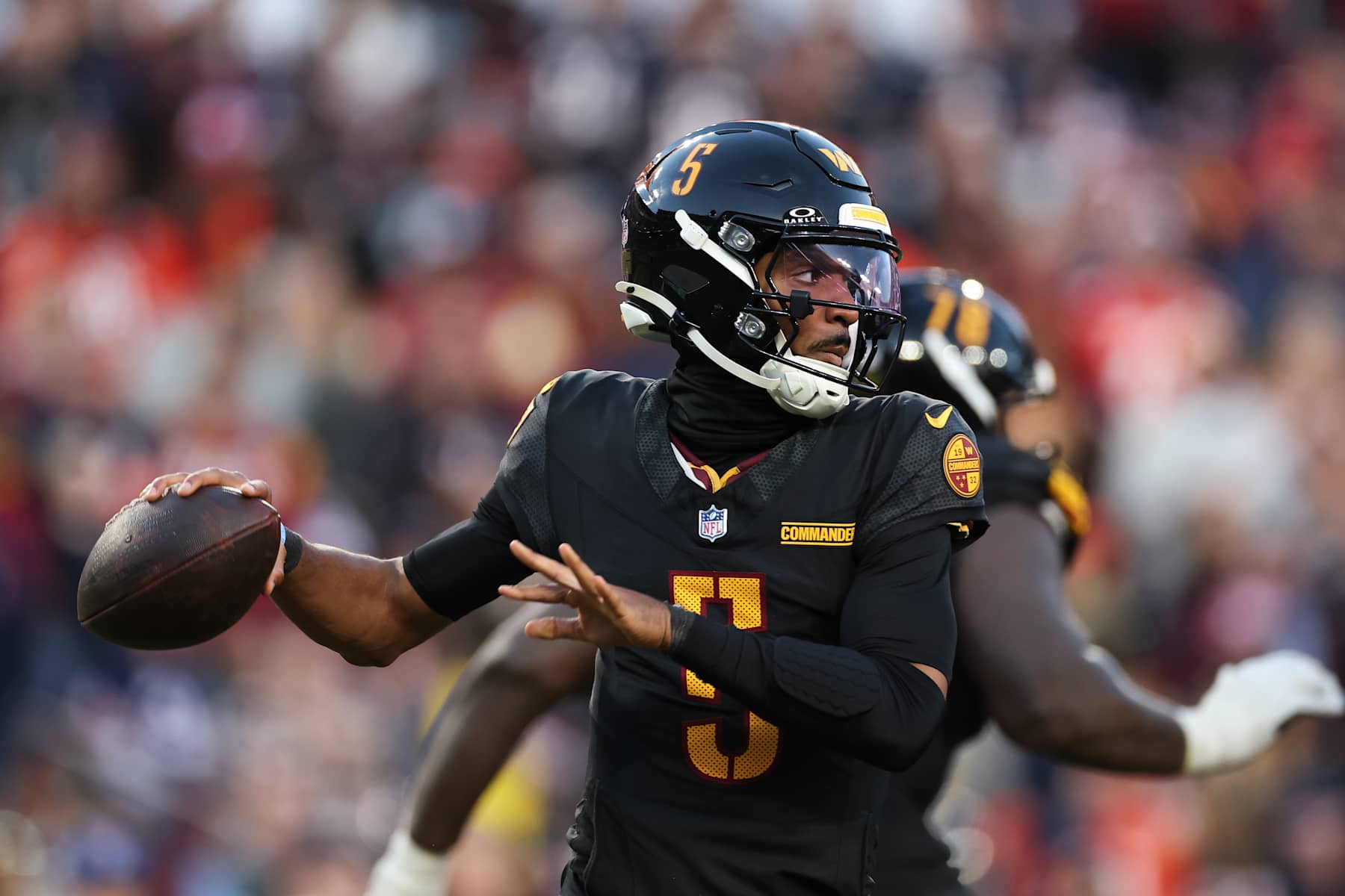LANDOVER, MARYLAND - OCTOBER 27: Jayden Daniels #5 of the Washington Commanders looks to pass the ball against the Chicago Bears during the second quarter at Northwest Stadium on October 27, 2024 in Landover, Maryland. (Photo by Scott Taetsch/Getty Images)