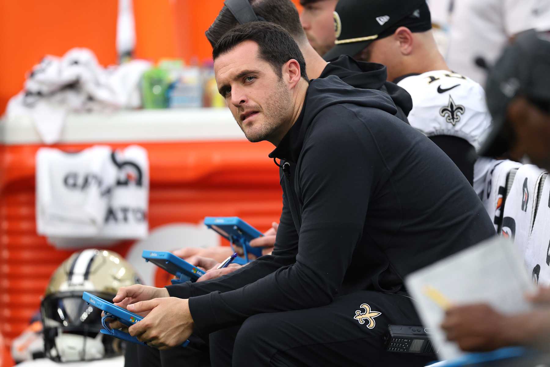 INGLEWOOD, CALIFORNIA - OCTOBER 27: Derek Carr #4 of the New Orleans Saints looks on from the bench in the third quarter of a game against the Los Angeles Chargers at SoFi Stadium on October 27, 2024 in Inglewood, California. (Photo by Harry How/Getty Images)