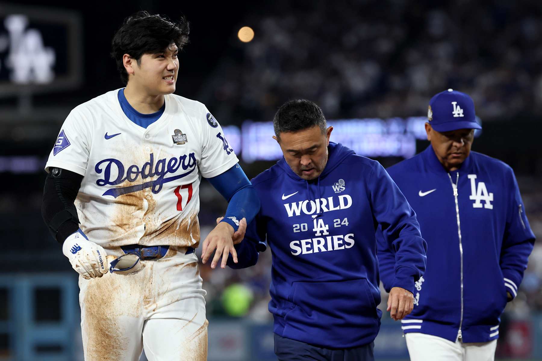 LOS ANGELES, CA - OCTOBER 26, 2024: Los Angeles Dodgers two-way player Shohei Ohtani (17) is led off the field after being injured in the seventh inning. Game 2 of the World Series against the Yankees at Dodgers Stadium in Los Angeles Friday, October. 25. 2024. (Robert Gauthier/Los Angeles Times via Getty Images)