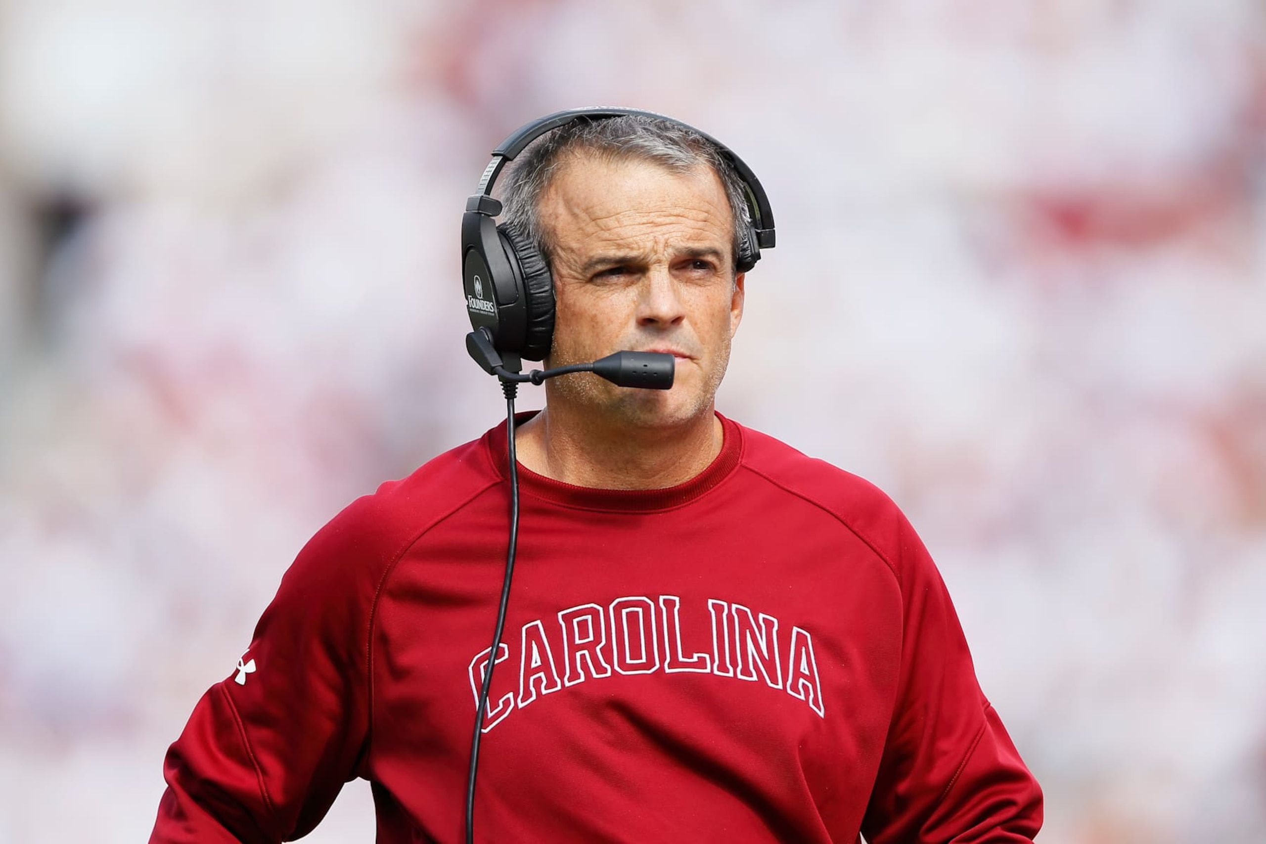 NORMAN, OKLAHOMA - OCTOBER 19: Head coach Shane Beamer of the South Carolina Gamecocks listens to the coaching staff during a game against the Oklahoma Sooners in the first quarter at Gaylord Family Oklahoma Memorial Stadium on October 19, 2024 in Norman, Oklahoma. South Carolina won 35-9. (Photo by Brian Bahr/Getty Images) NORMAN, OKLAHOMA - OCTOBER 19: Head coach Shane Beamer of the South Carolina Gamecocks listens to the coaching staff during a game against the Oklahoma Sooners in the first quarter at Gaylord Family Oklahoma Memorial Stadium on October 19, 2024 in Norman, Oklahoma. South Carolina won 35-9. (Photo by Brian Bahr/Getty Images)