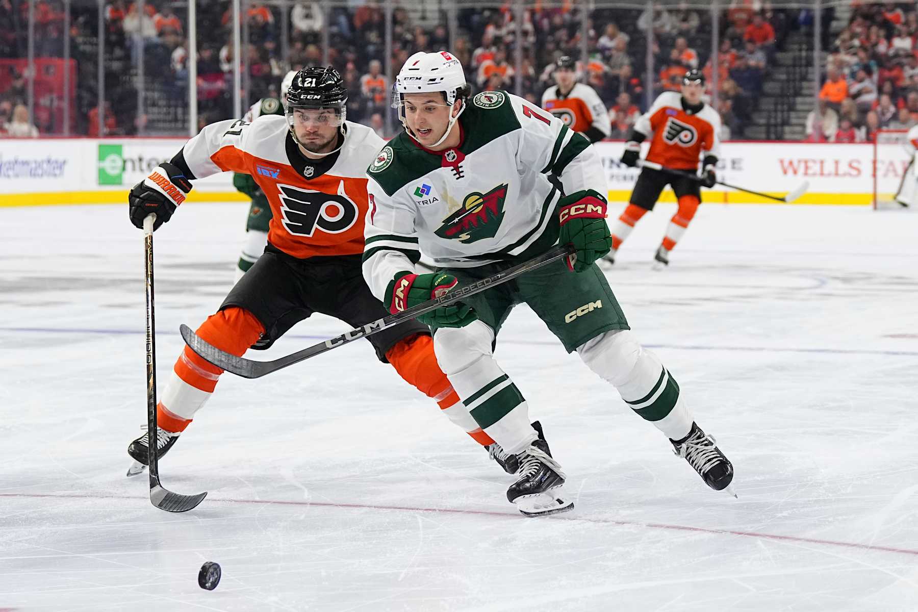 PHILADELPHIA, PENNSYLVANIA - OCTOBER 26: Scott Laughton #21 of the Philadelphia Flyers battles with Brock Faber #7 of the Minnesota Wild at the Wells Fargo Center on October 26, 2024 in Philadelphia, Pennsylvania. The Flyers defeated the Wild 7-5. (Photo by Mitchell Leff/Getty Images)