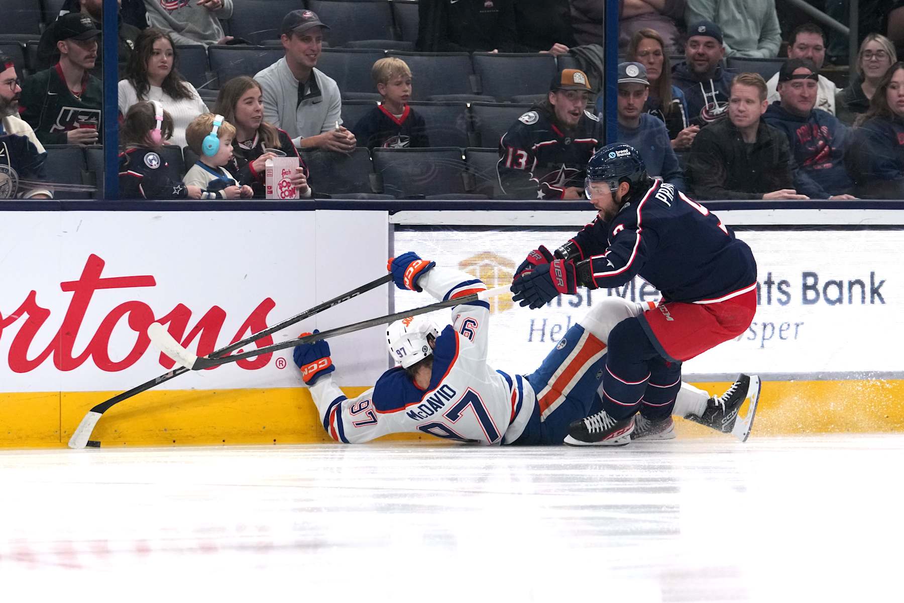COLUMBUS, OHIO - OCTOBER 28: Ivan Provorov #9 of the Columbus Blue Jackets hits Connor McDavid #97 of the Edmonton Oilers into the boards during the first period at Nationwide Arena on October 28, 2024 in Columbus, Ohio. (Photo by Jason Mowry/Getty Images)