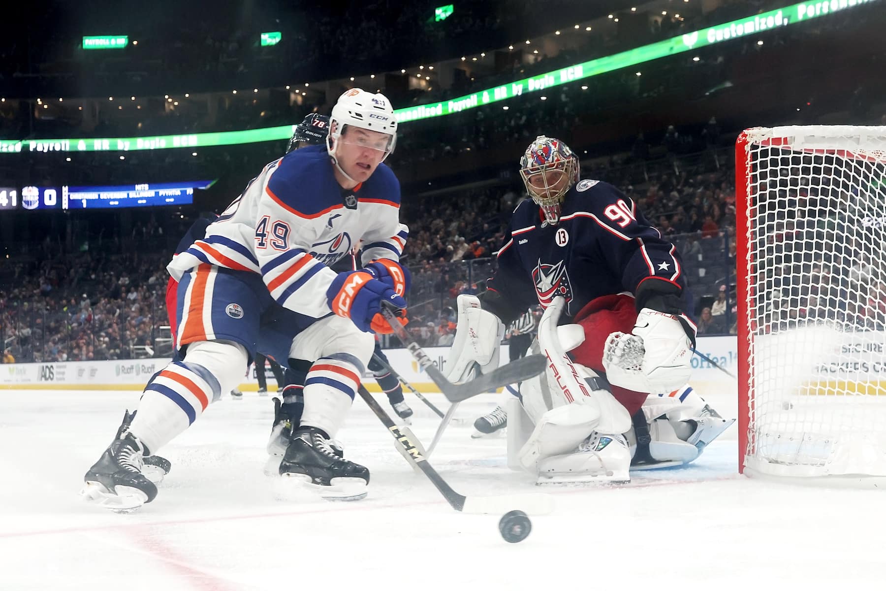 COLUMBUS, OHIO - OCTOBER 28: Ty Emberson #49 of the Edmonton Oilers gathers up the puck as it slides past Elvis Merzlikins #90 of the Columbus Blue Jackets during the third period of the game at Nationwide Arena on October 28, 2024 in Columbus, Ohio. Columbus defeated Edmonton 6-1. (Photo by Kirk Irwin/NHLI via Getty Images)