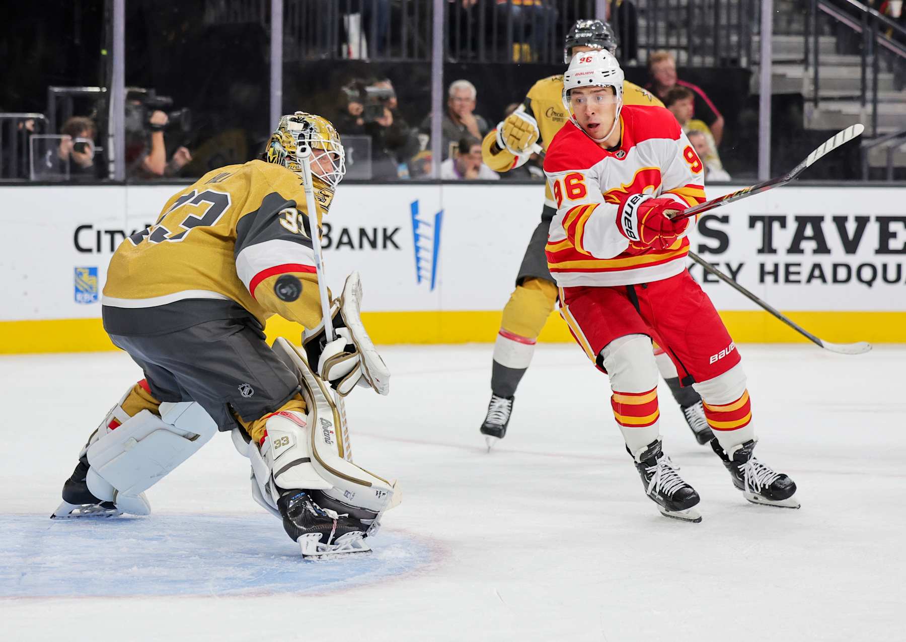 LAS VEGAS, NEVADA - OCTOBER 28: Adin Hill #33 of the Vegas Golden Knights defends the net against Andrei Kuzmenko #96 of the Calgary Flames in the first period of their game at T-Mobile Arena on October 28, 2024 in Las Vegas, Nevada. (Photo by Ethan Miller/Getty Images)