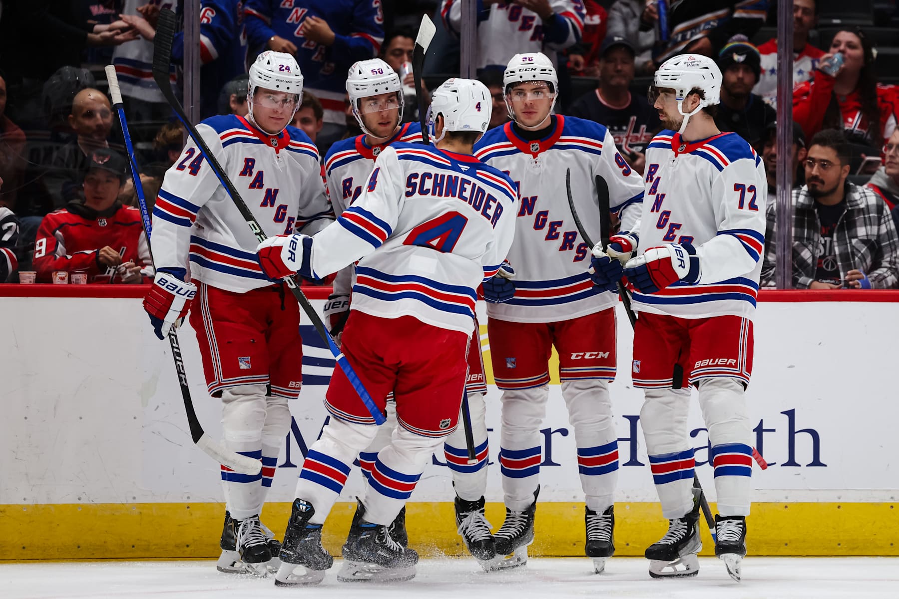 WASHINGTON, DC - OCTOBER 29: Will Cuylle #50 of the New York Rangers celebrates with teammates after scoring a coal against the Washington Capitals during the first period of the game at Capital One Arena on October 29, 2024 in Washington, DC. (Photo by Scott Taetsch/Getty Images)