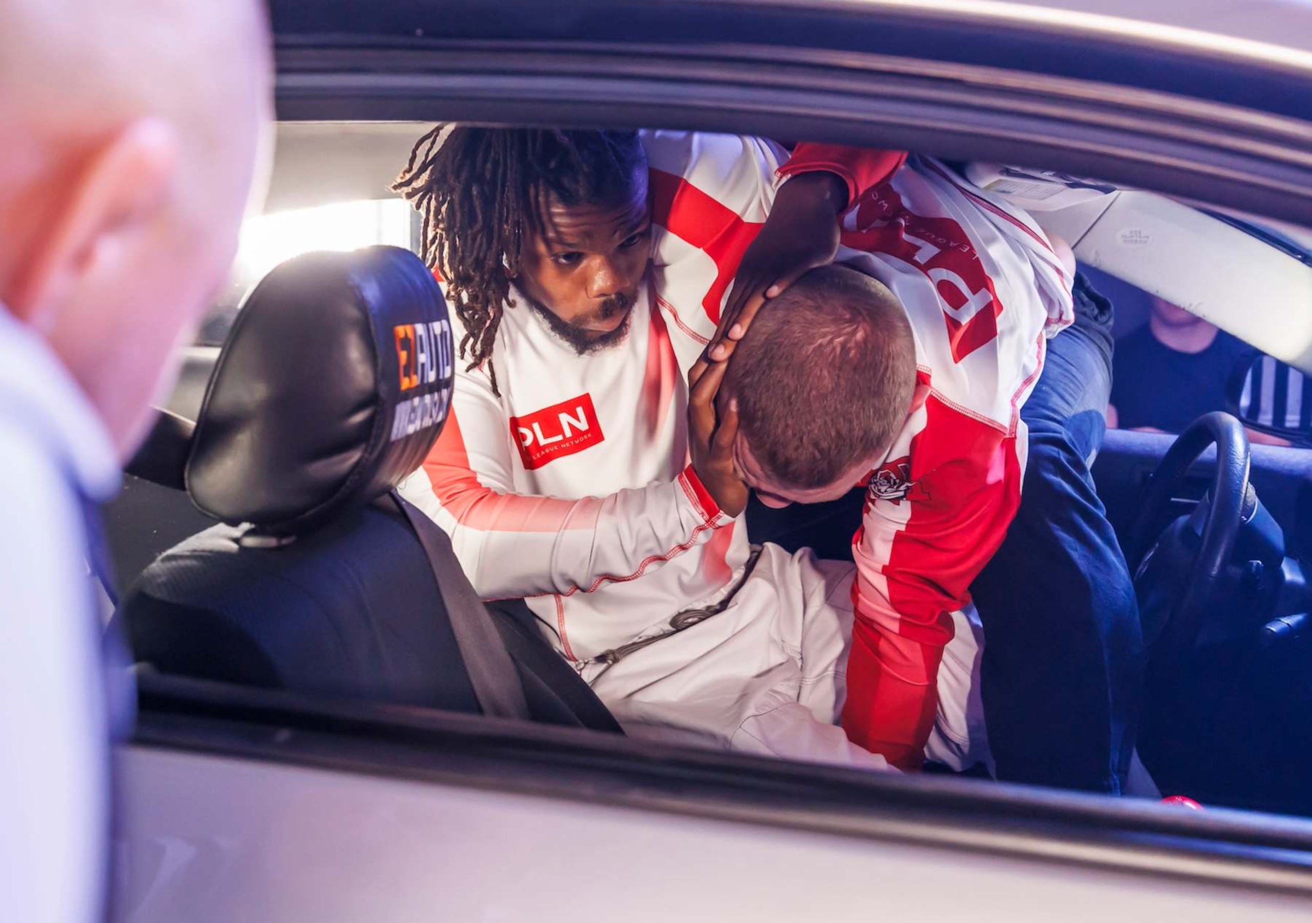 Two jiu jitsu athletes compete in a Car-Jitsu match. 