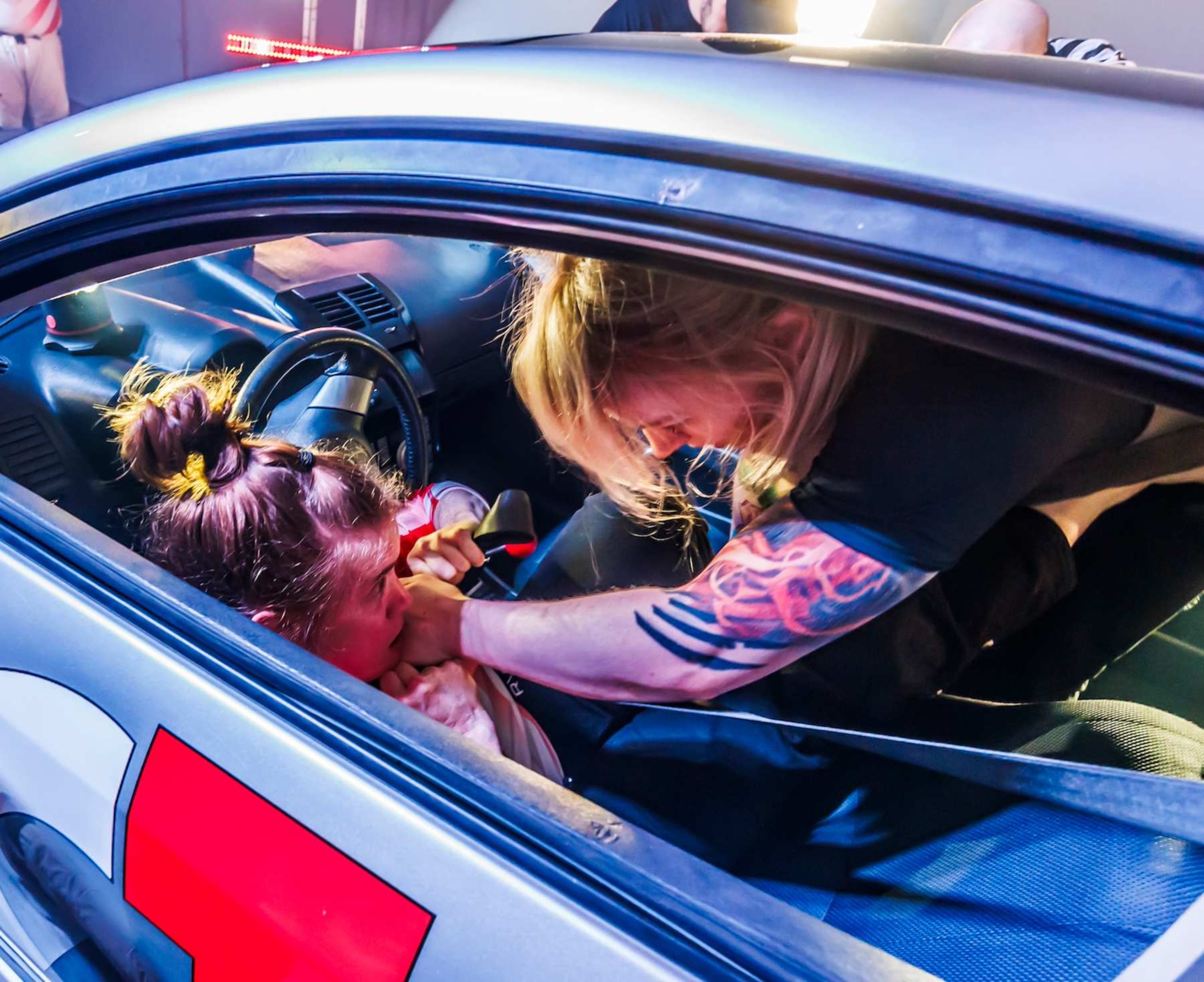 Two women battle inside a Toyota Scion as part of a Car-Jitsu match.